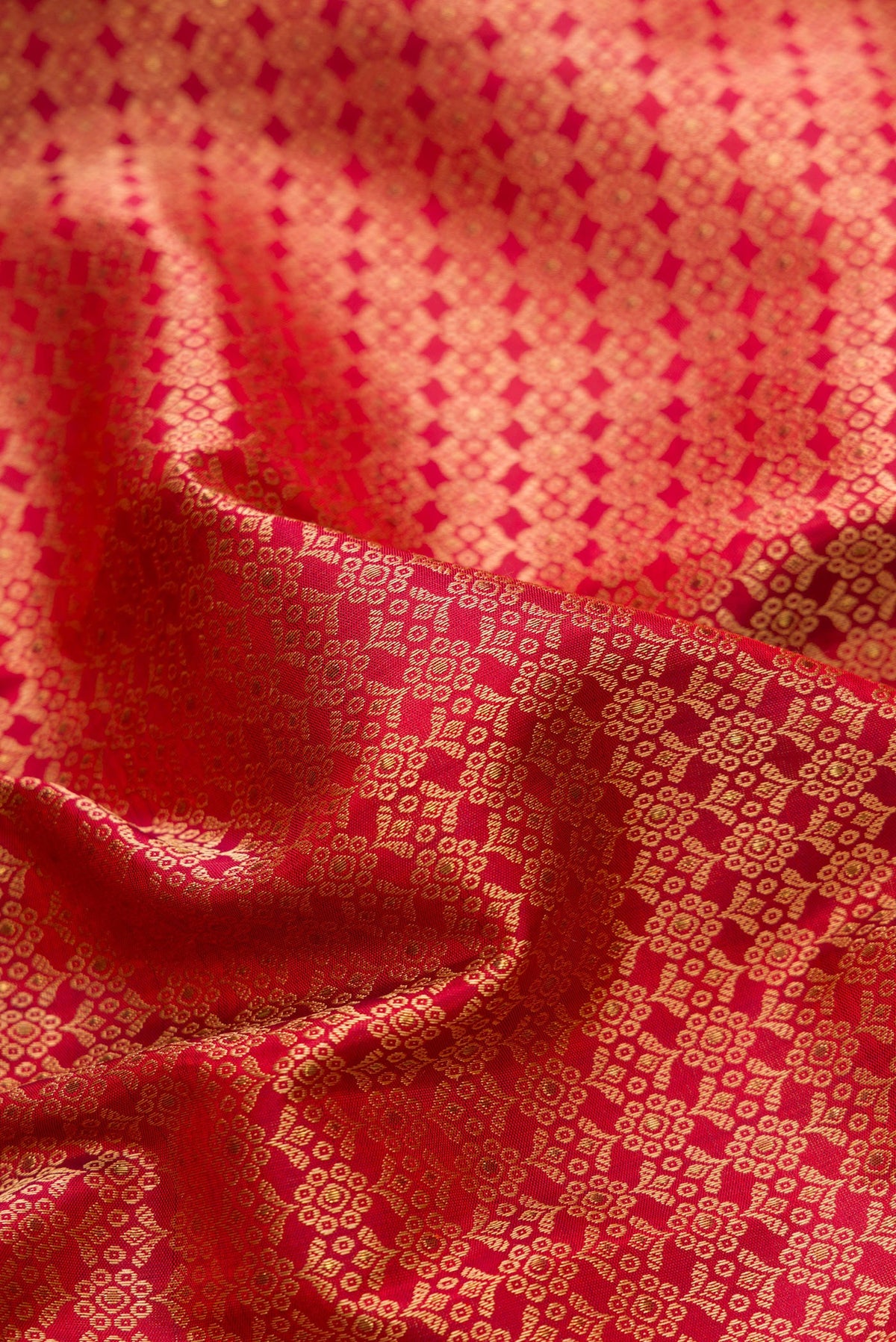 Close up of Pure Silk Pure Zari Maroon Dual Tone Kanchipuram Saree with Jacquard design on the body and Fancy Border.  displaying folds