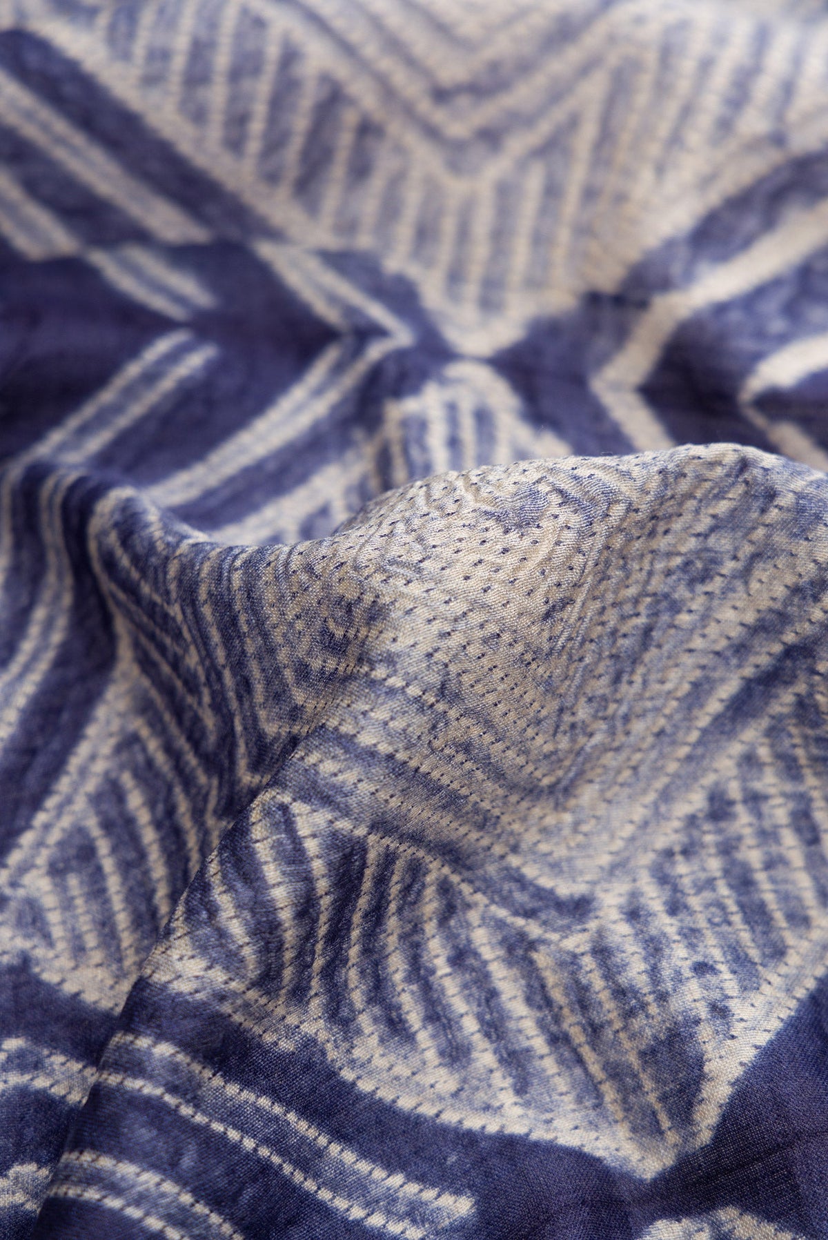 Close up of Navy Blue Dual Tone Tussar Silk Saree with Printed design on the body and Printed Border.  displaying folds