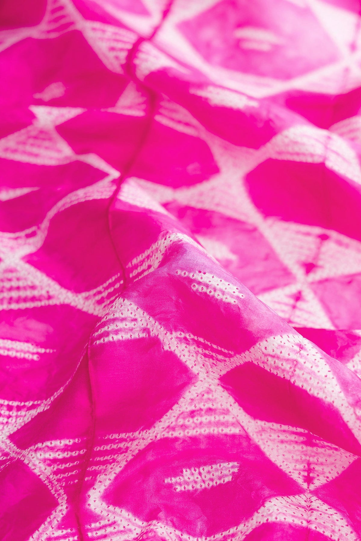 Close up of Pink Dual Tone Tussar Silk Saree with Printed design on the body and Plain Border.  displaying folds