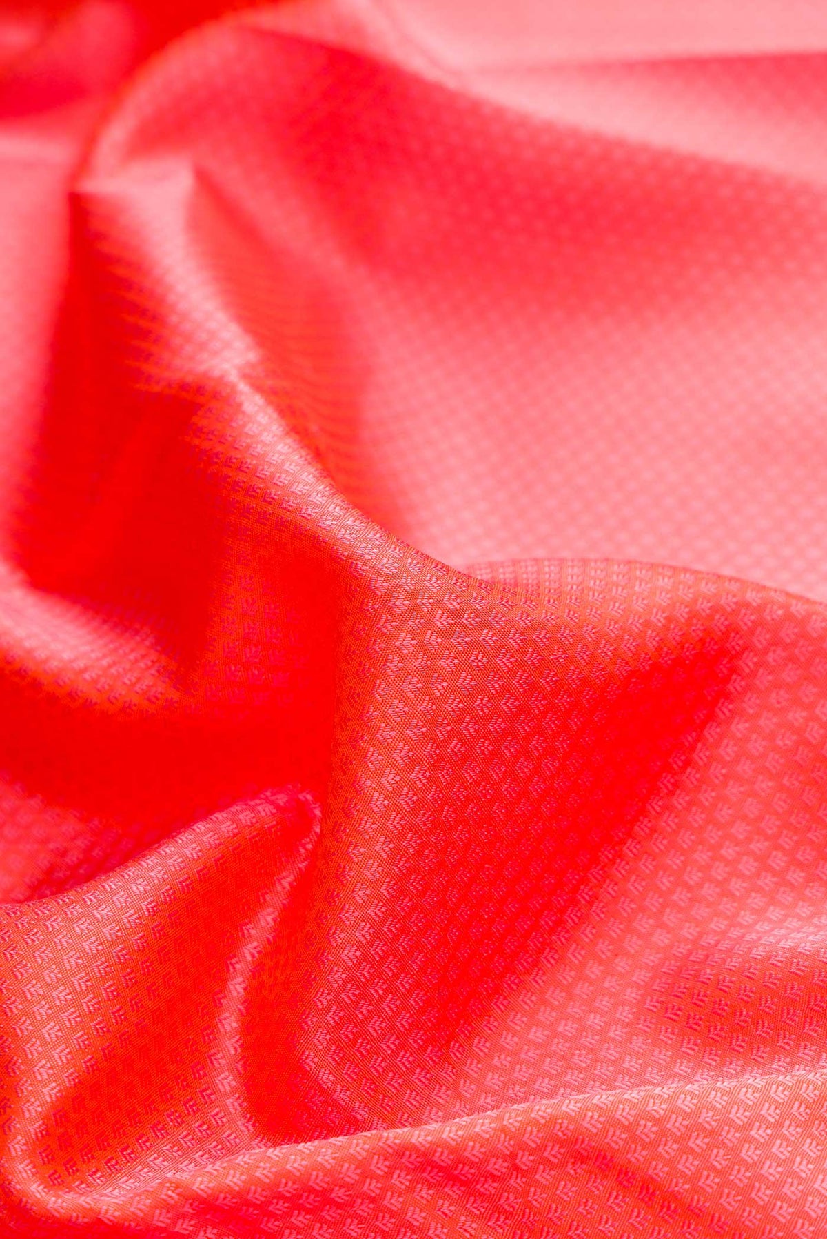Close up of Orange Dual Tone Kanchipuram Silk Saree with Jacquard design on the body and Zari Border displaying folds