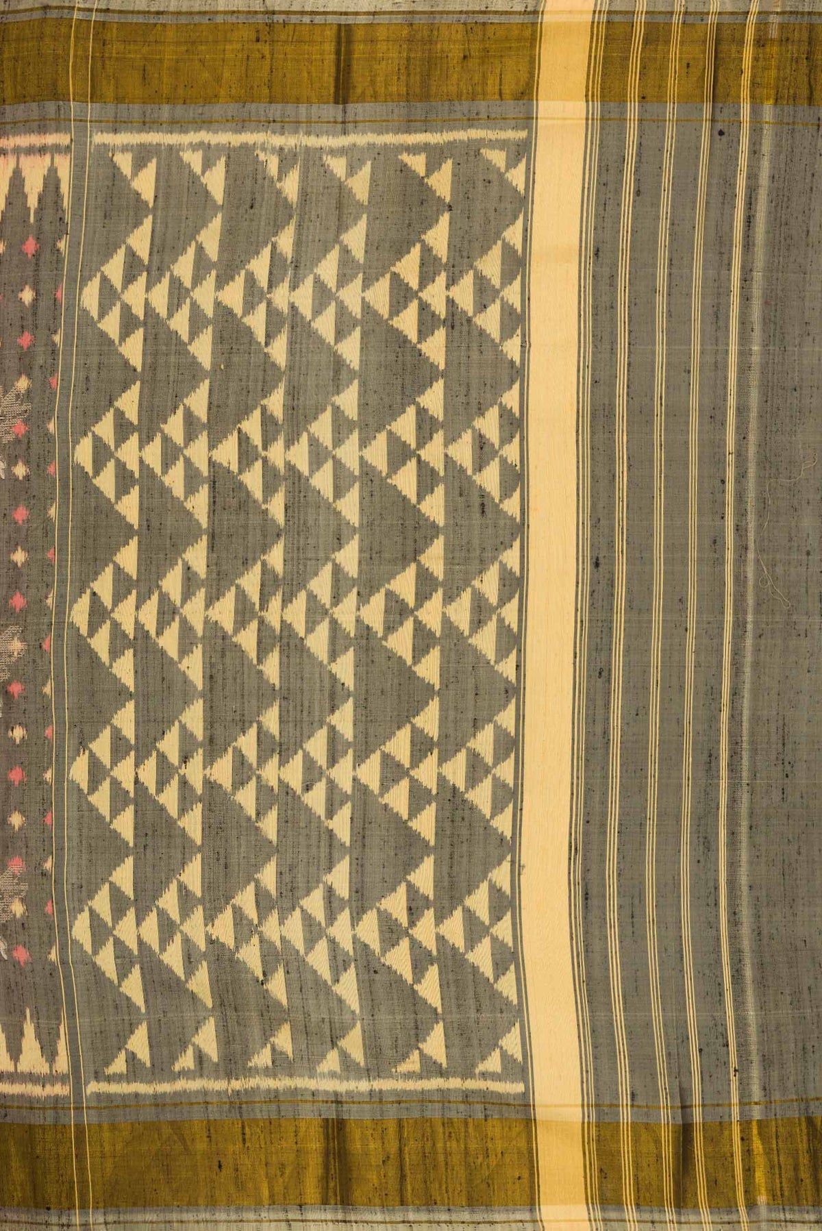 Close up image of the pallu of Grey Dual Tone Rajkot Patola Silk Saree with Ikat Print on the body and Zari Border