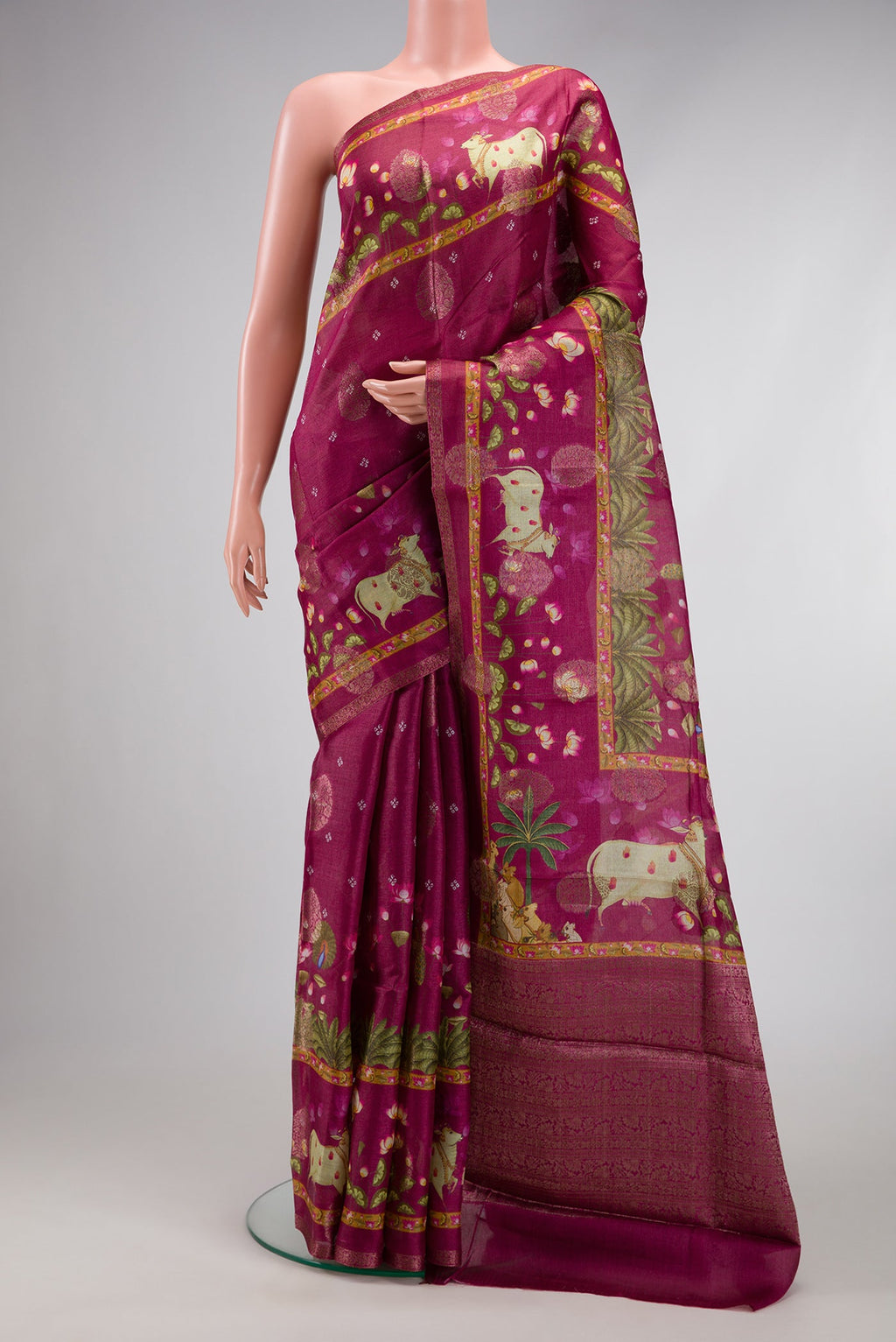Maroon Tussar Silk Saree with Printed design on the body and Fancy Border.  displayed on a mannequin
