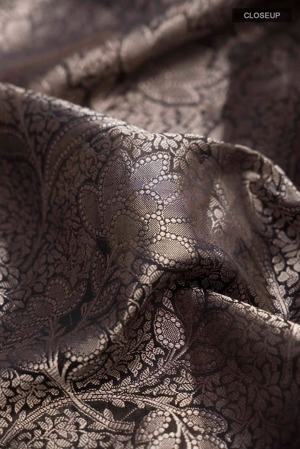 Close up of Black Banarasi Silk Saree with Zari Brocade on the body and Printed Border displaying folds