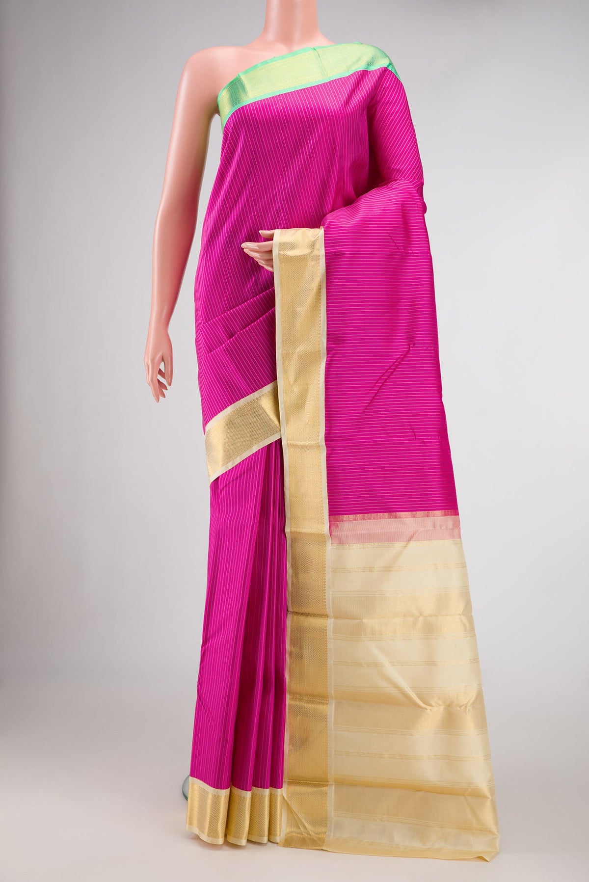 Pink Dual Tone Kanjivaram Silk Saree with Stripes on the body and Ganga Jamuna Border.  displayed on a mannequin