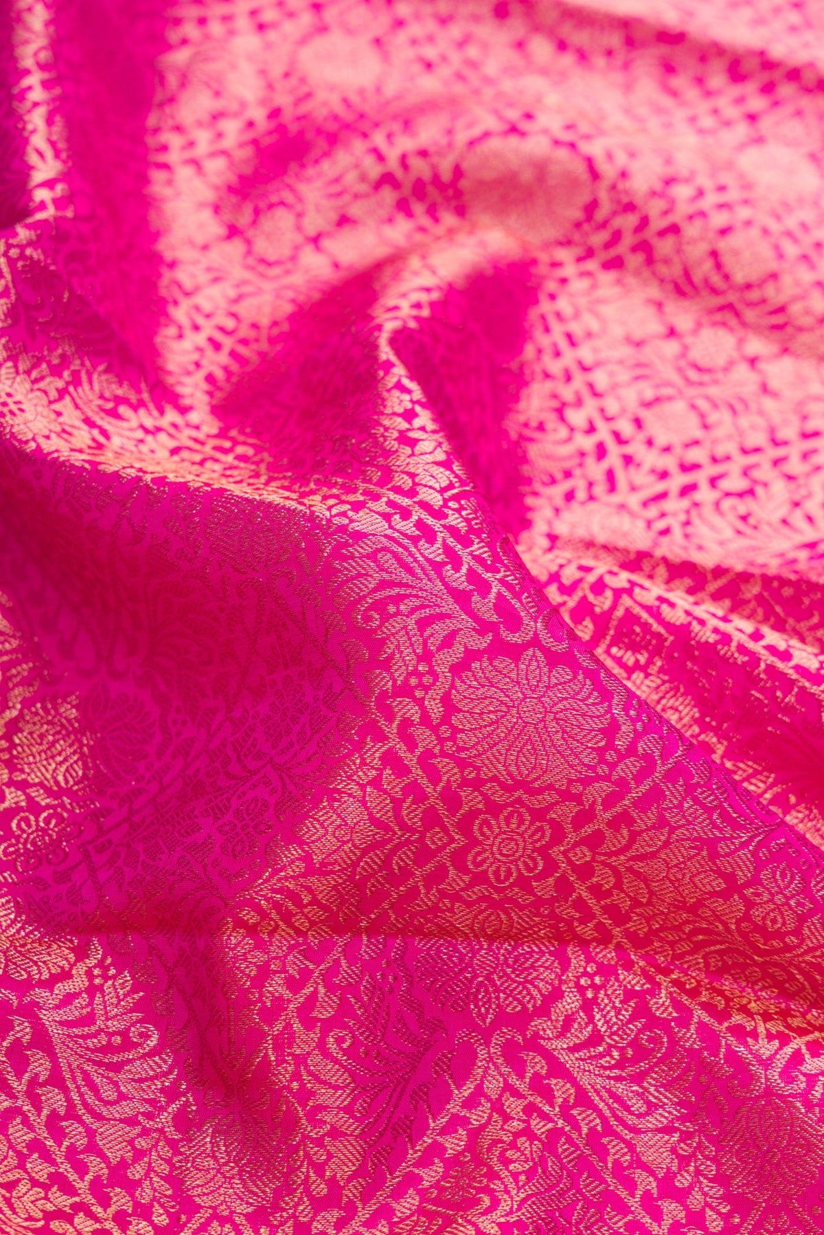 Close up of Pink Dual Tone Kanchipuram Silk Saree with Zari Brocade on the body and Zari Border.  displaying folds