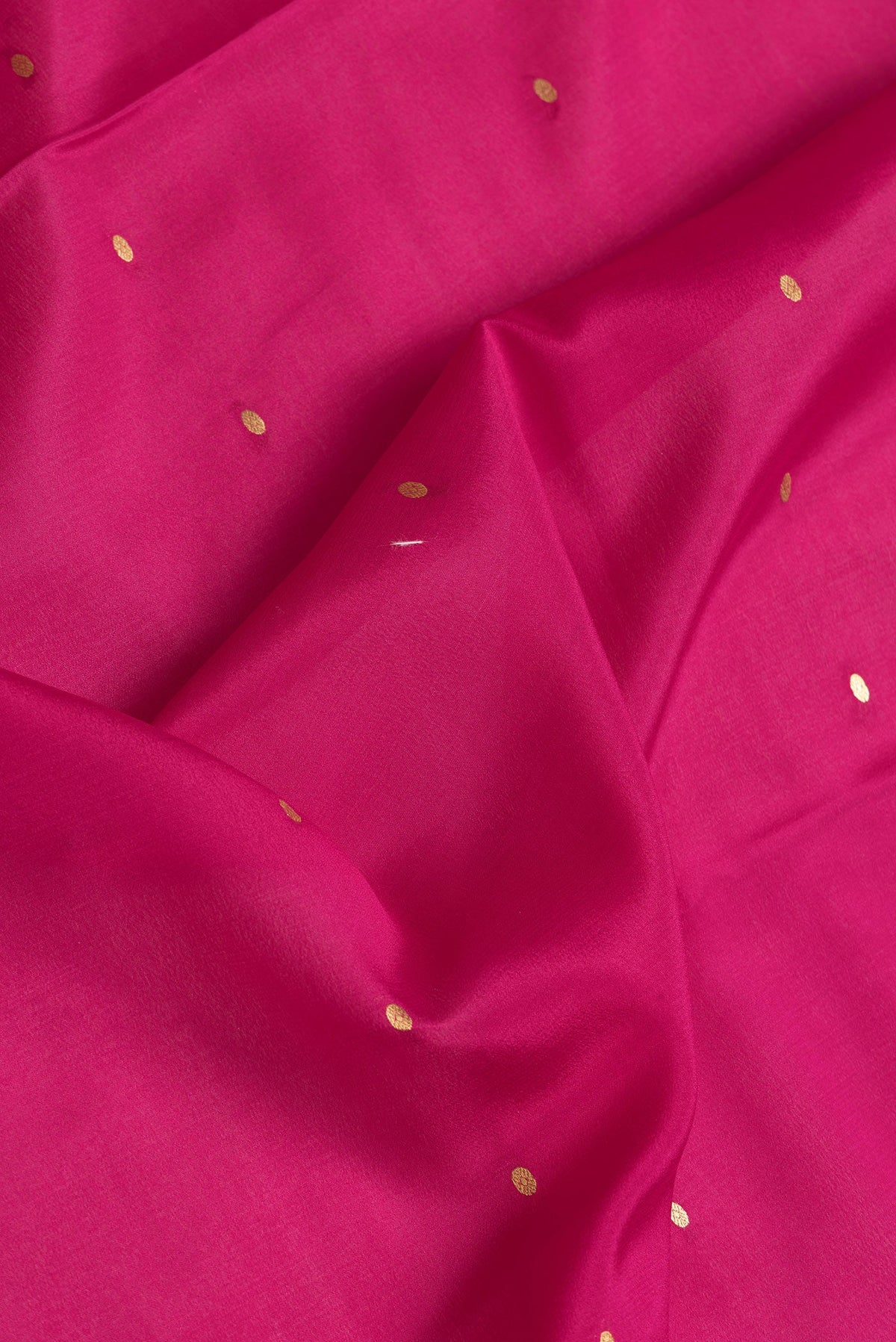 Close up of Magenta Dual Tone Mysore Silk Saree with Zari Butta on the body and Zari Border.  displaying folds