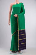 Pure Silk Pure Zari Green Mysore Crepe Saree with Plain Body and Zari Border displayed on a mannequin