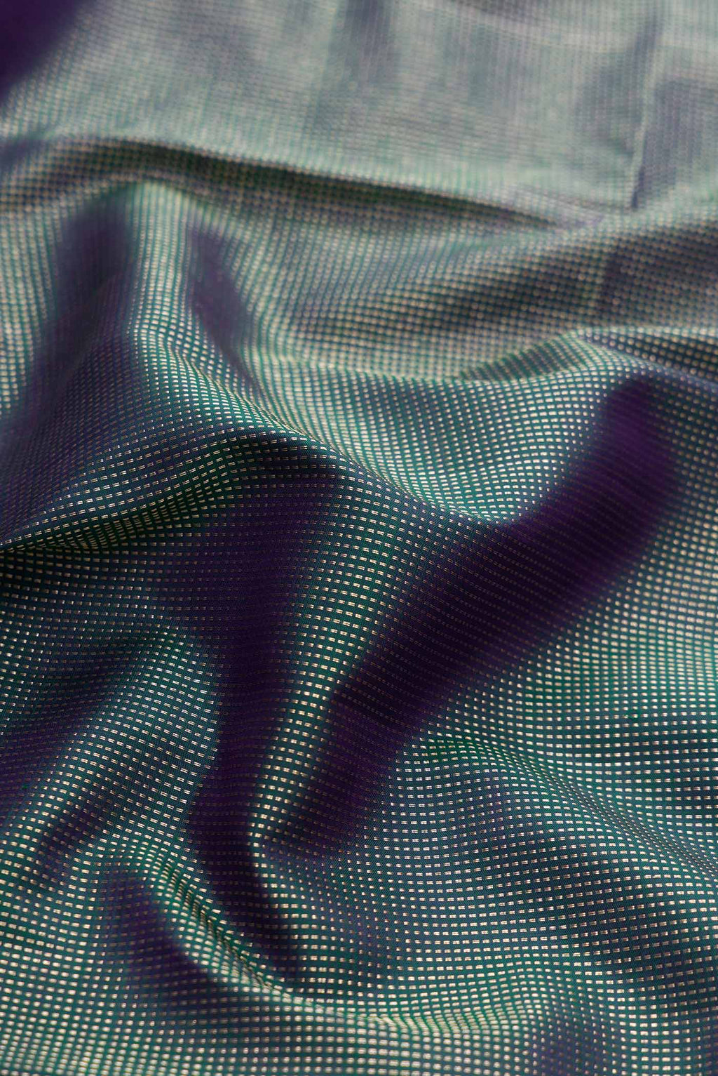 Close up of Peacock Blue Dual Tone Kanchipuram Silk Saree with Zari Brocade on the body and Fancy Border displaying folds
