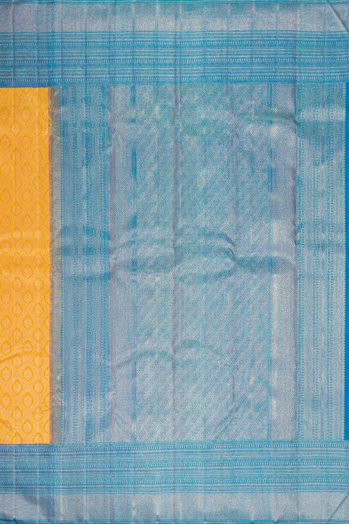 Close up image of the pallu of Yellow Kanchipuram Silk Saree with Zari Brocade on the body and Zari Border