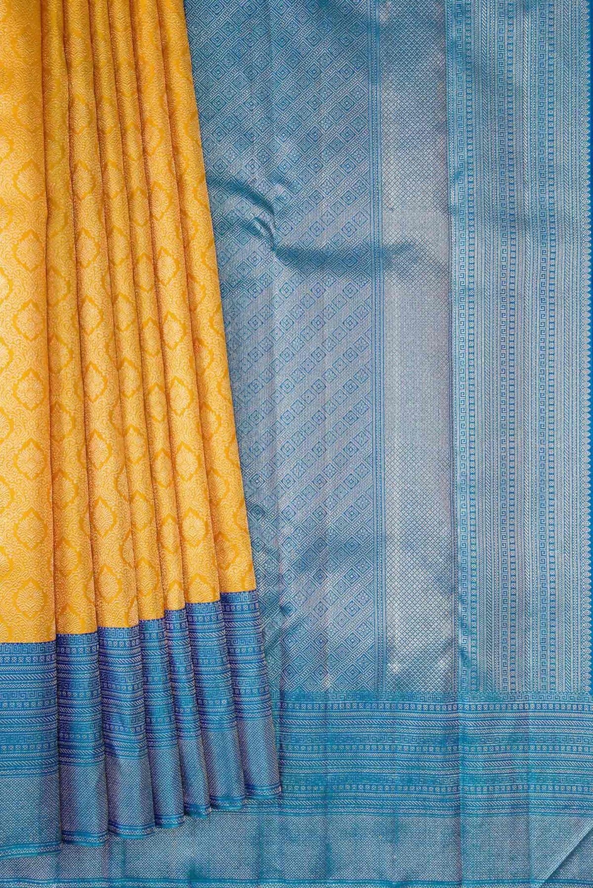 Pleats and pallu of Yellow Kanchipuram Silk Saree with Zari Brocade on the body and Zari Border