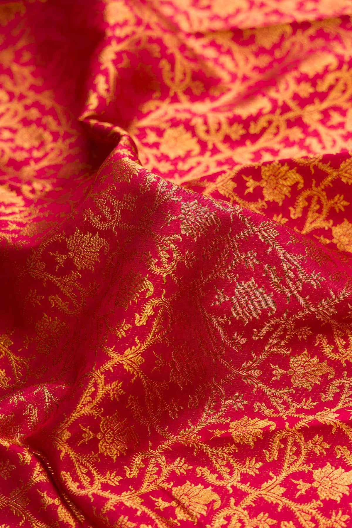 Close up of Maroon Dual Tone Kanchipuram Saree with Zari Brocade on the body and Zari Border displaying folds