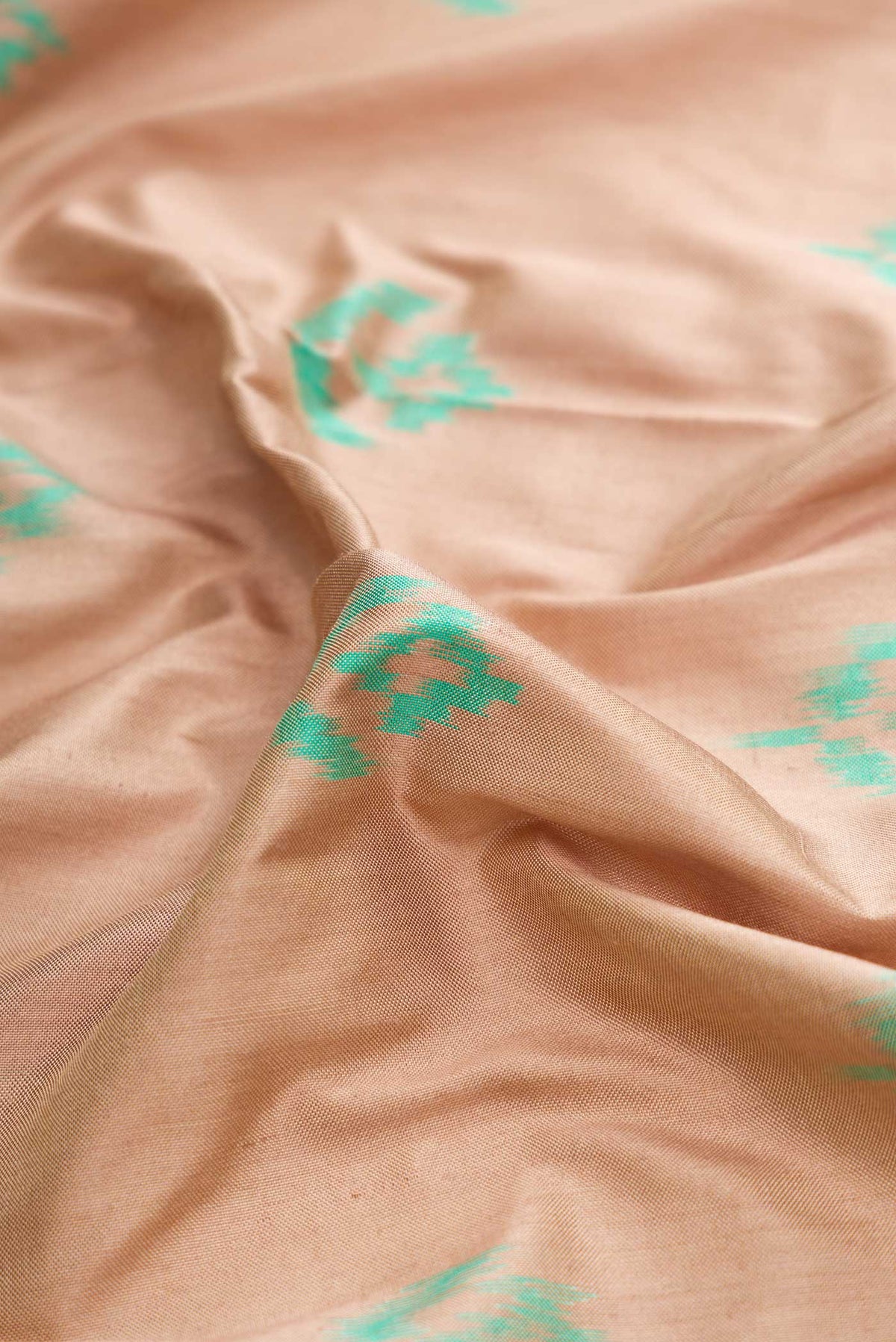 Close up of Brown Dual Tone Double Ikat Saree with Ikat Print on the body and Ikat Border displaying folds