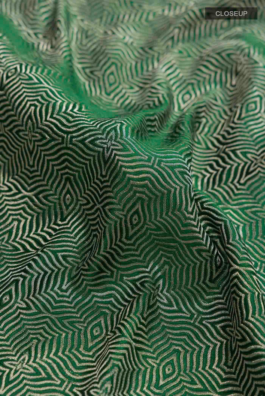 Close up of Green Mysore Crepe Saree with Zari Brocade on the body and Zari Border displaying folds