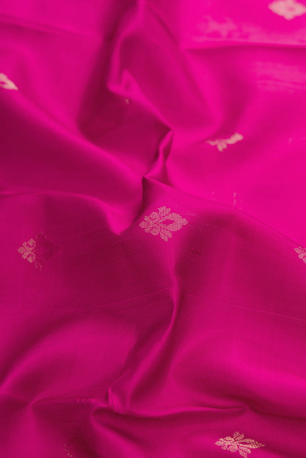 Close up of Light Magenta Dual Tone Soft Silk Saree with Zari Butta on the body and Zari Border displaying folds