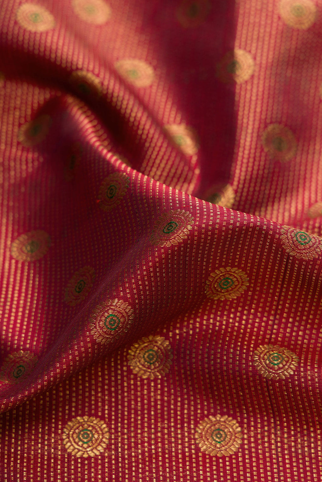 Close up of Maroon Dual Tone Kanchipuram Silk Saree with Zari Brocade on the body and Zari Border.  displaying folds