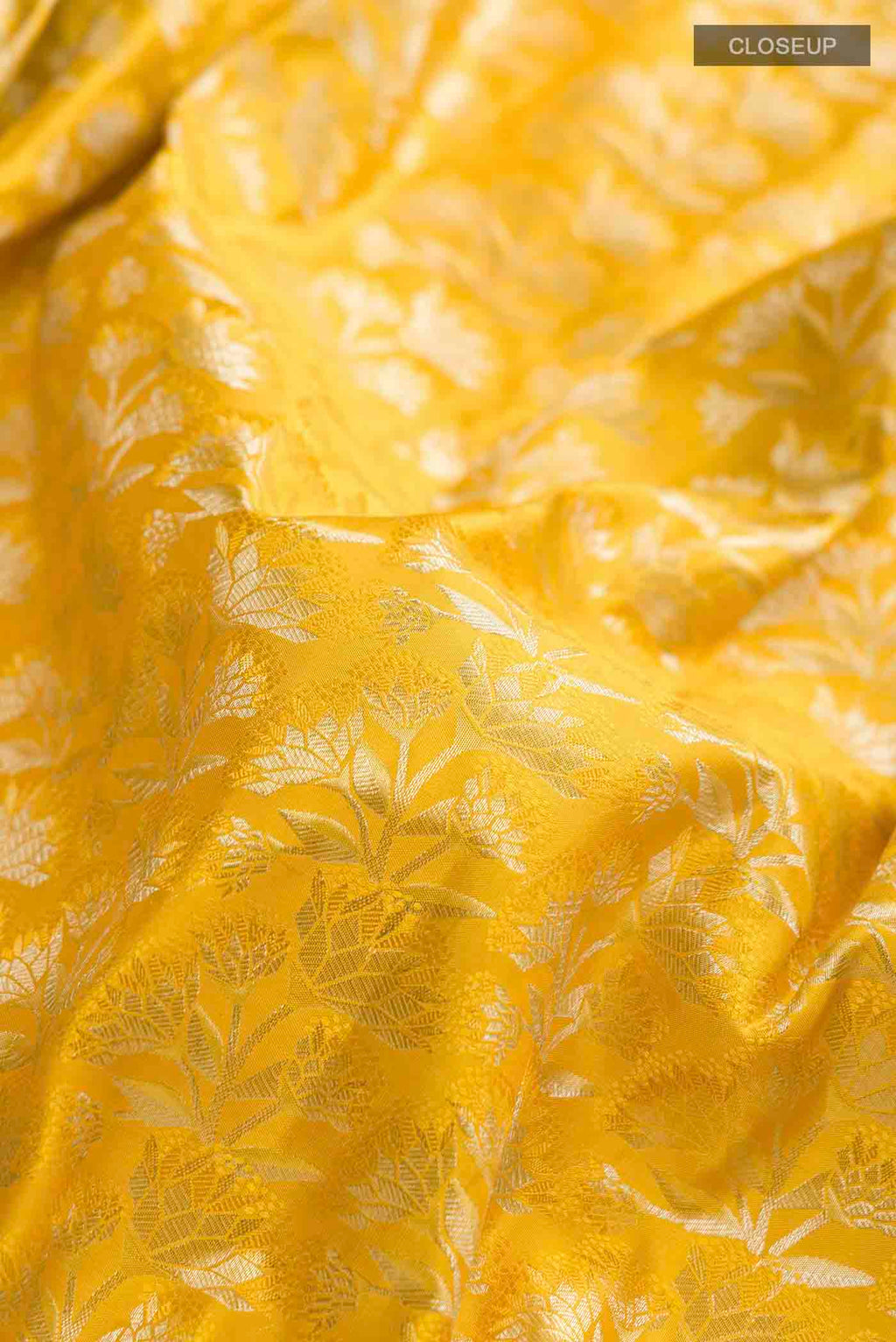 Close up of Yellow Kanchipuram Silk Saree with Zari Brocade on the body and Zari Border displaying folds