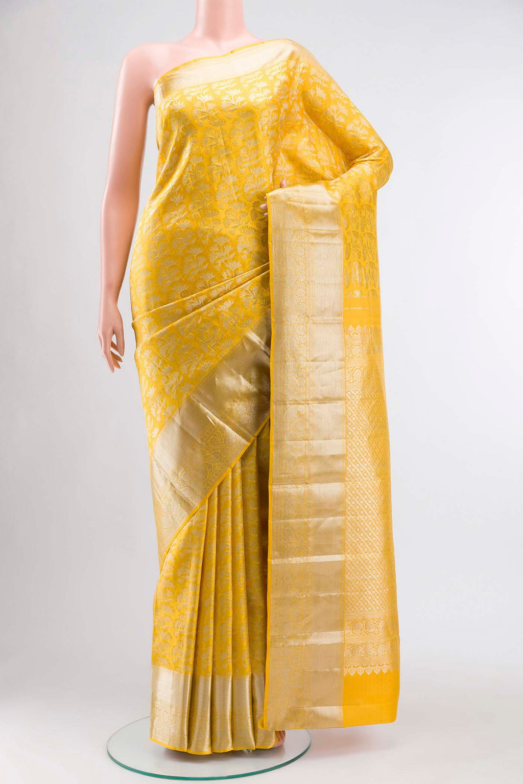 Yellow Kanchipuram Silk Saree with Zari Brocade on the body and Zari Border displayed on a mannequin