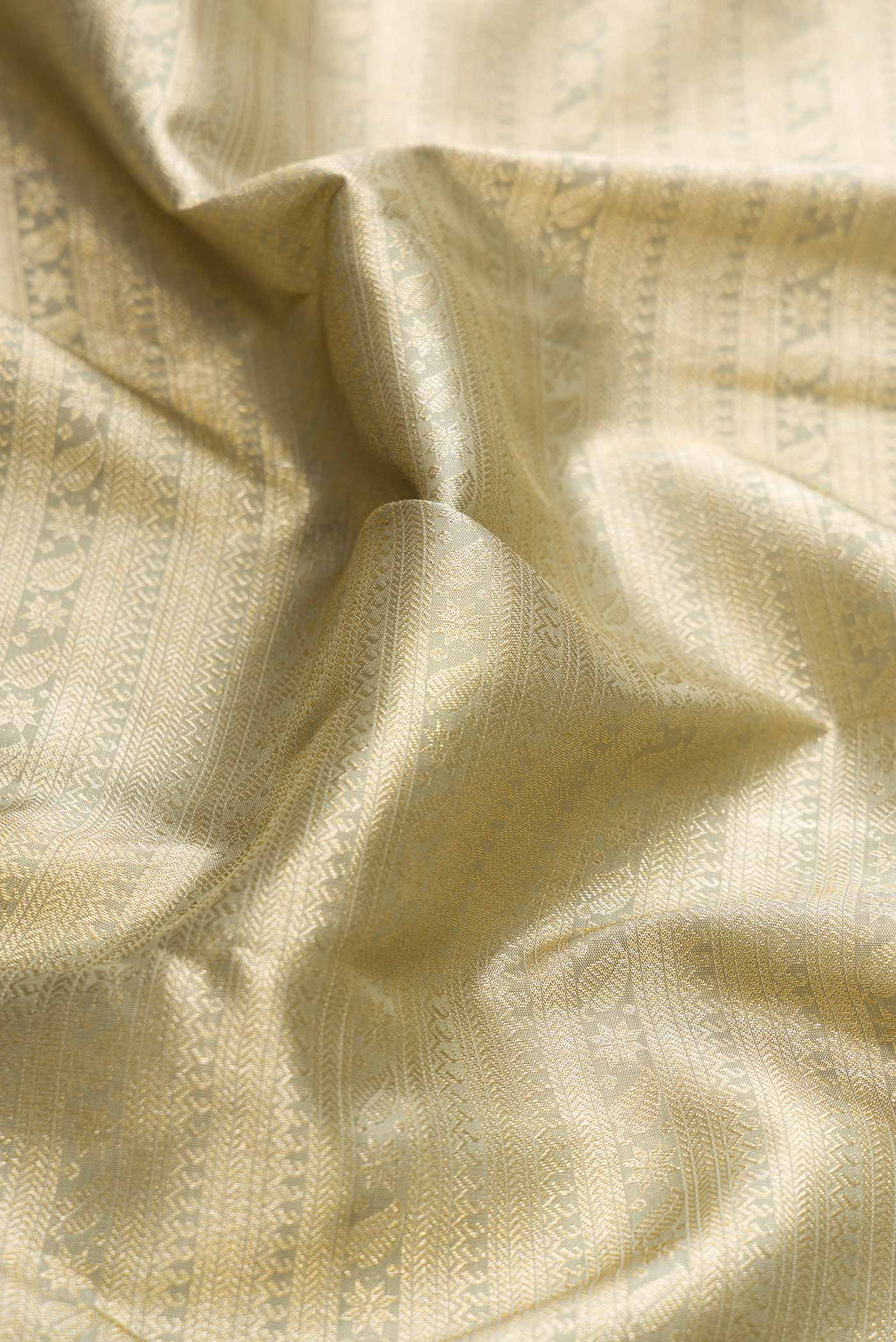 Close up of Light Green Dual Tone Kanchipuram Silk Saree with Zari Brocade on the body and Zari Border displaying folds