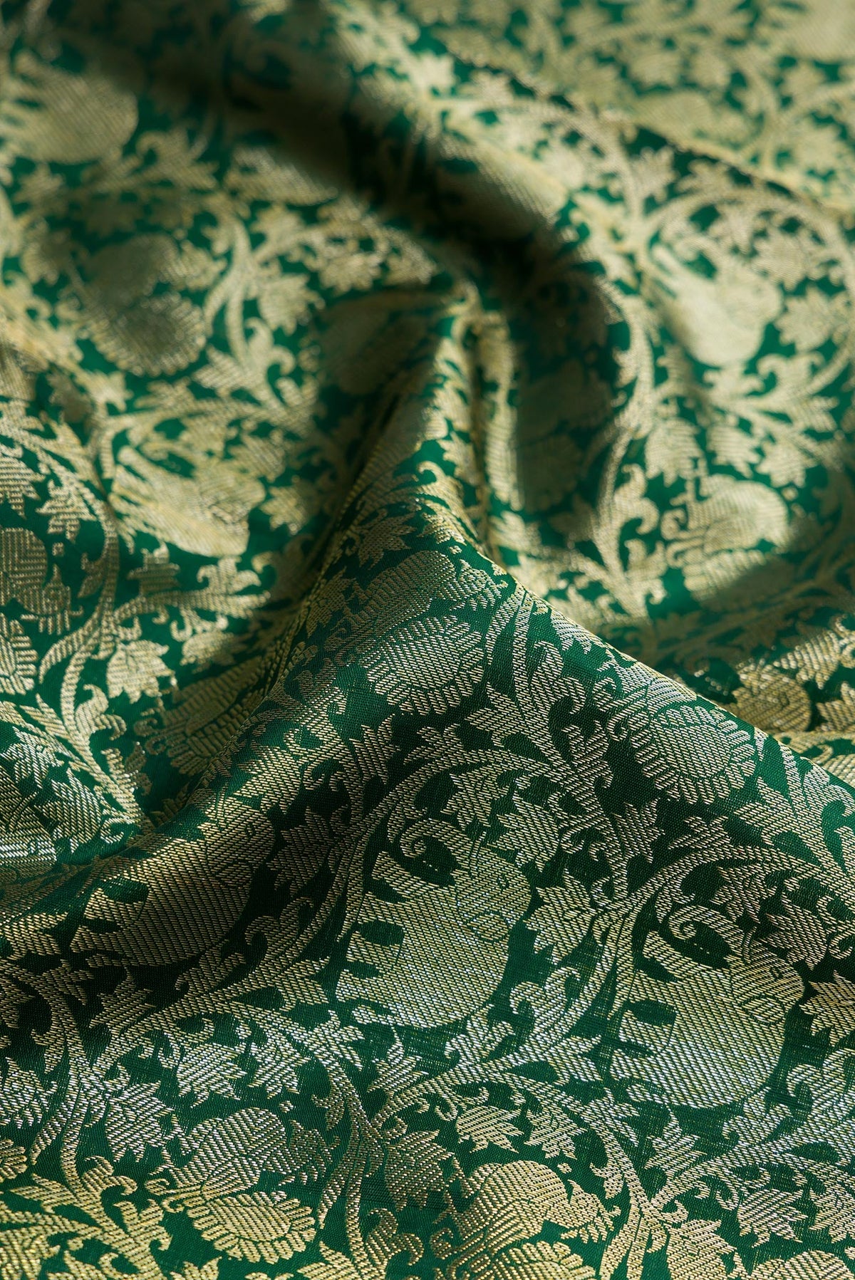 Close up of Green Dual Tone Kanchipuram Silk Saree with Zari Brocade on the body and Zari Border.  displaying folds