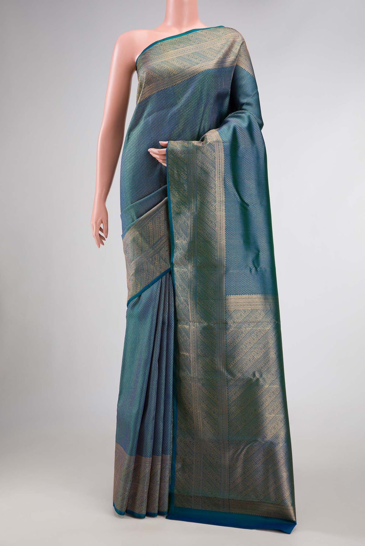 Peacock Blue Dual Tone Kanchipuram Silk Saree with Zari Brocade on the body and Zari Border.  displayed on a mannequin
