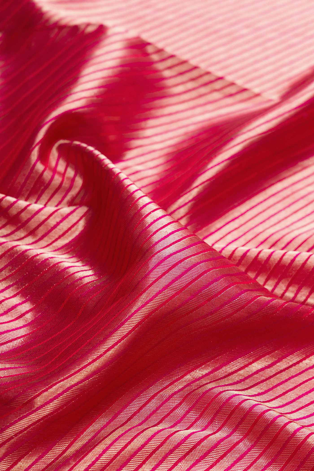 Close up of Pink Dual Tone Kanchipuram Silk Saree with Zari Brocade on the body and Zari Border displaying folds