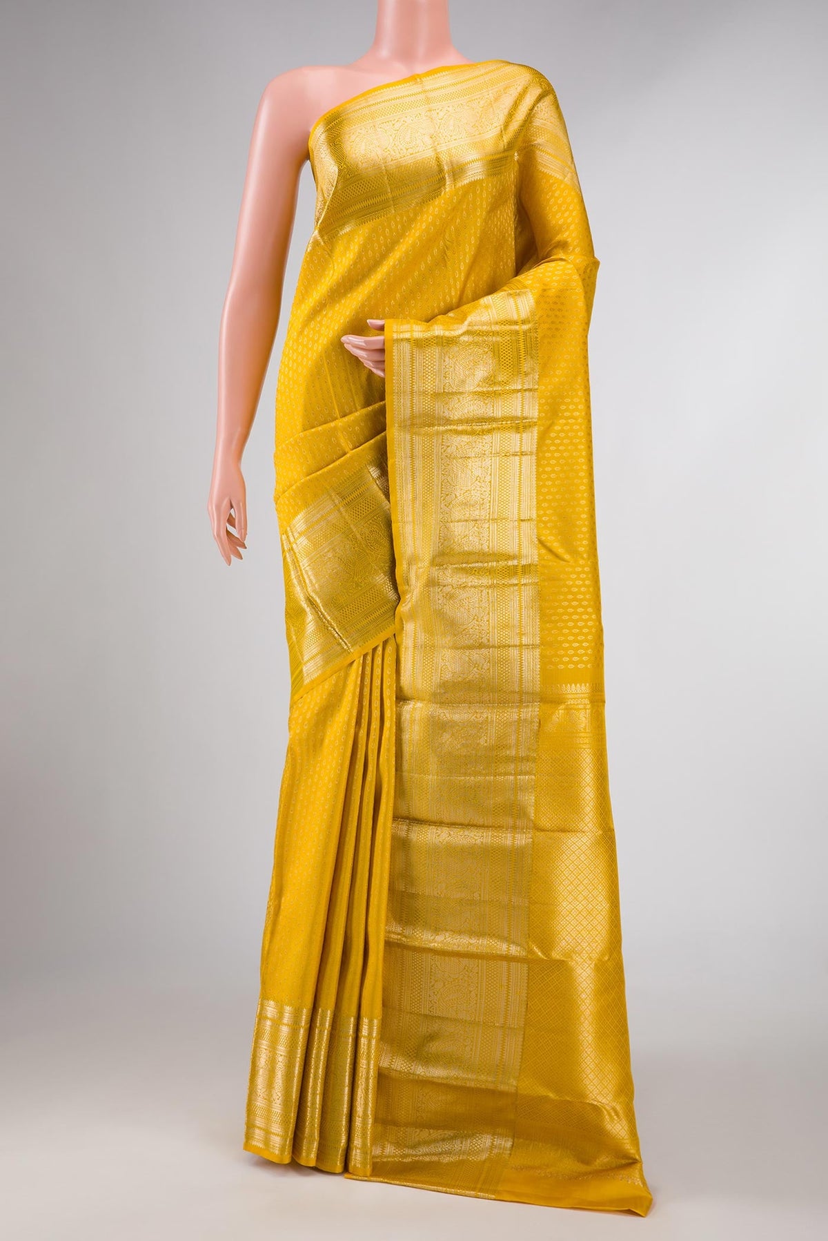 Yellow Dual Tone Kanchipuram Silk Saree with Zari Brocade on the body and Zari Border displayed on a mannequin