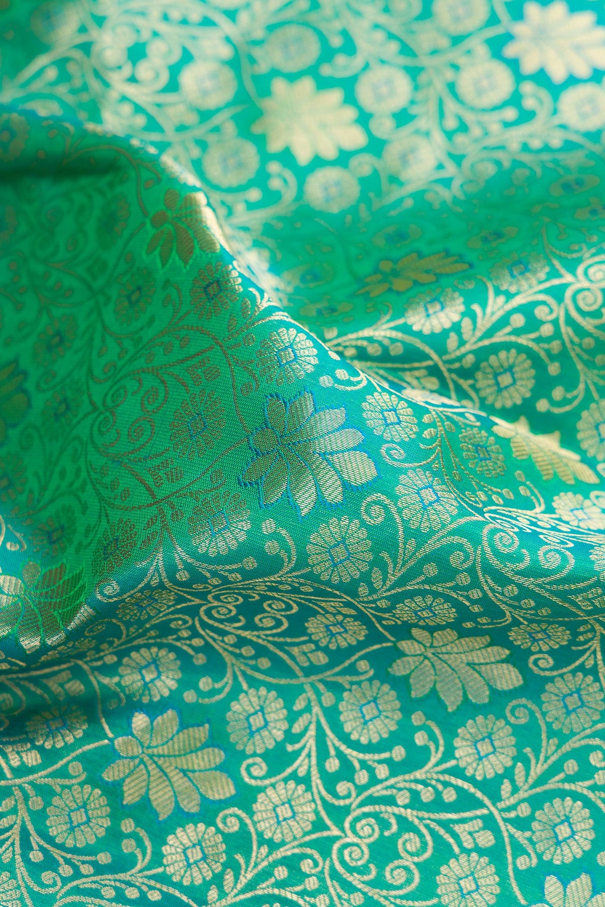Close up of Sea Green Kanchipuram Silk Saree with Zari Brocade on the body and Zari Border.  displaying folds