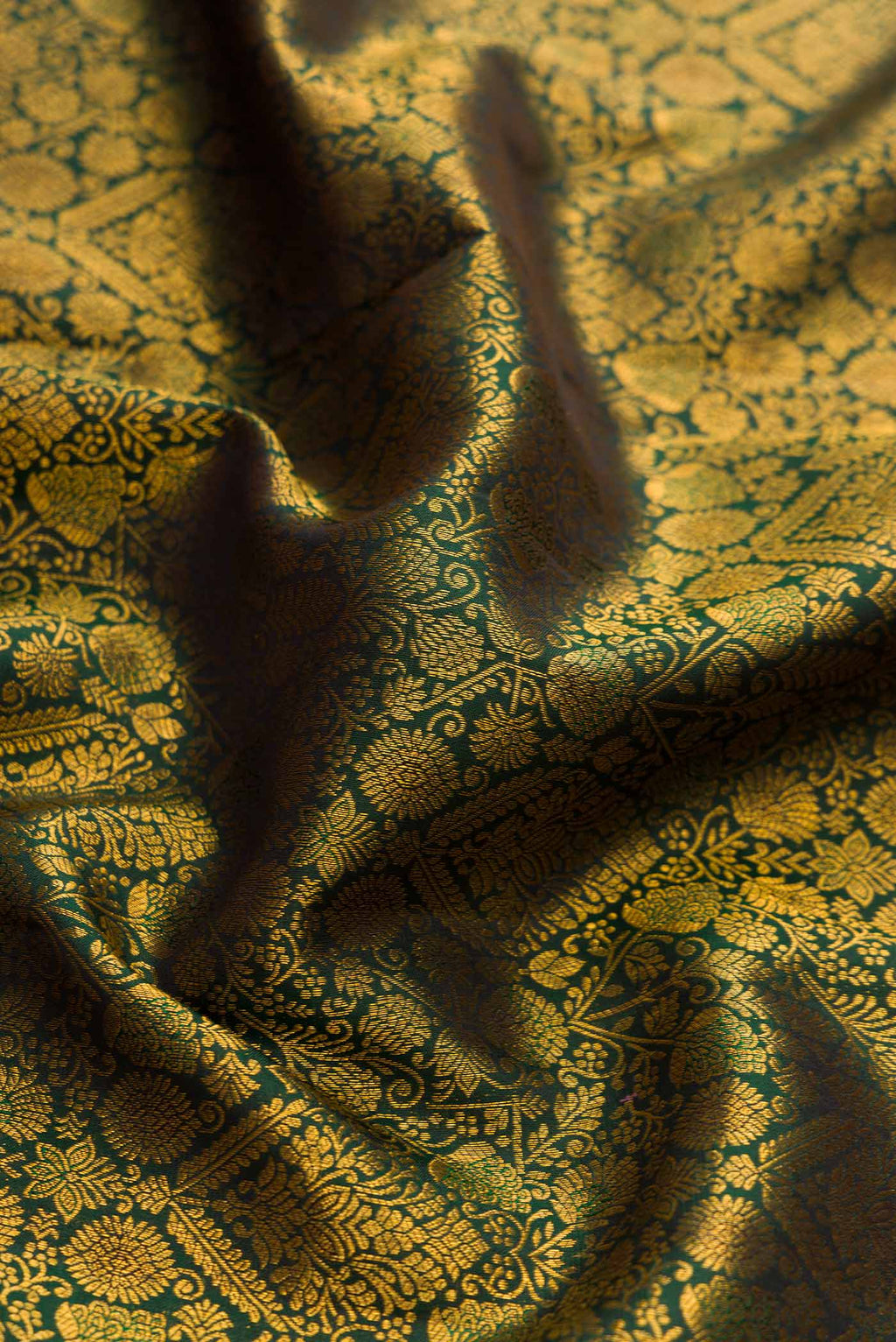 Close up of Green Dual Tone Kanchipuram Silk Saree with Zari Brocade on the body and Zari Border displaying folds