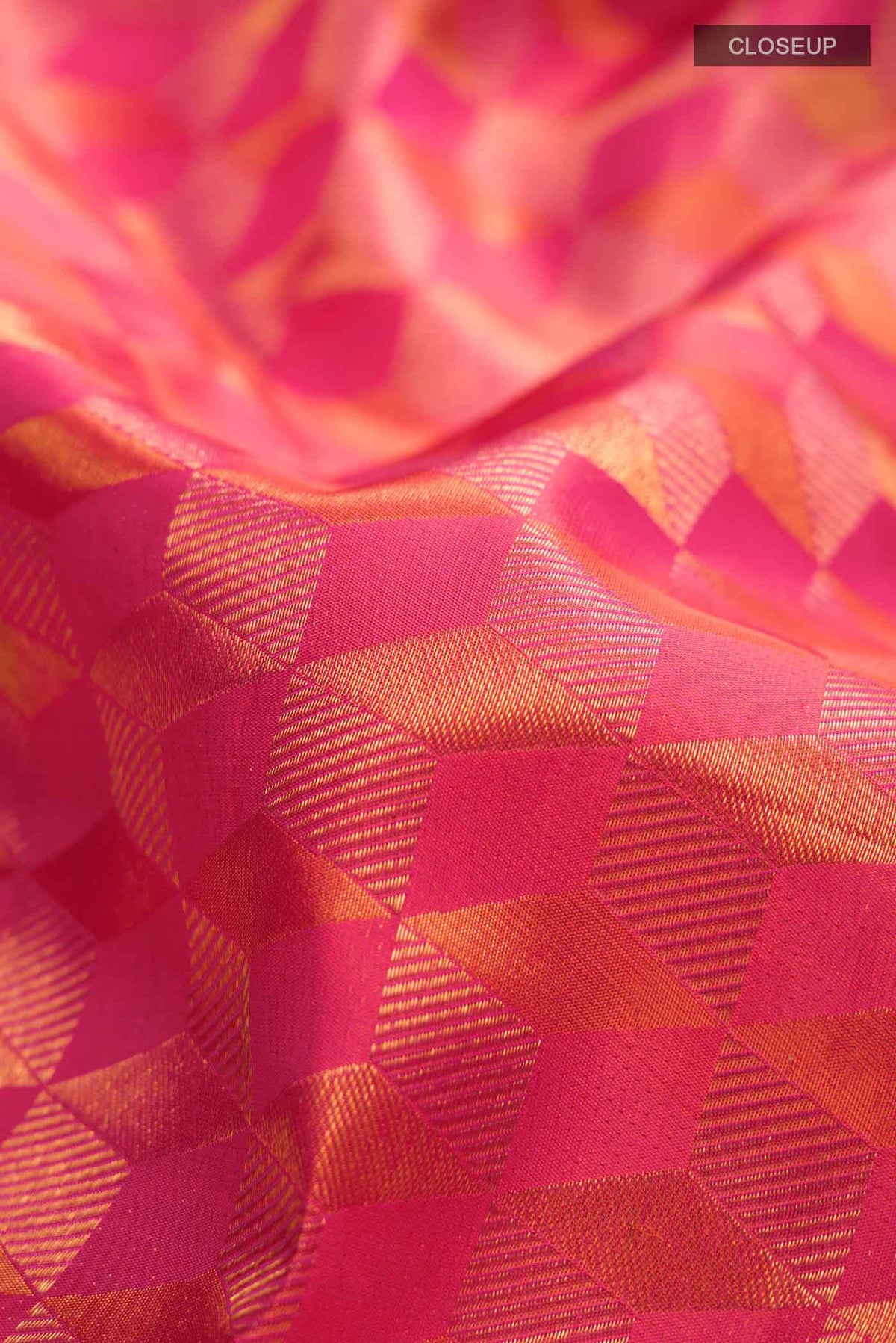 Close up of Pink with Orange Dual Tone Kanchipuram Silk Saree with Zari Brocade on the body and Zari Border displaying folds