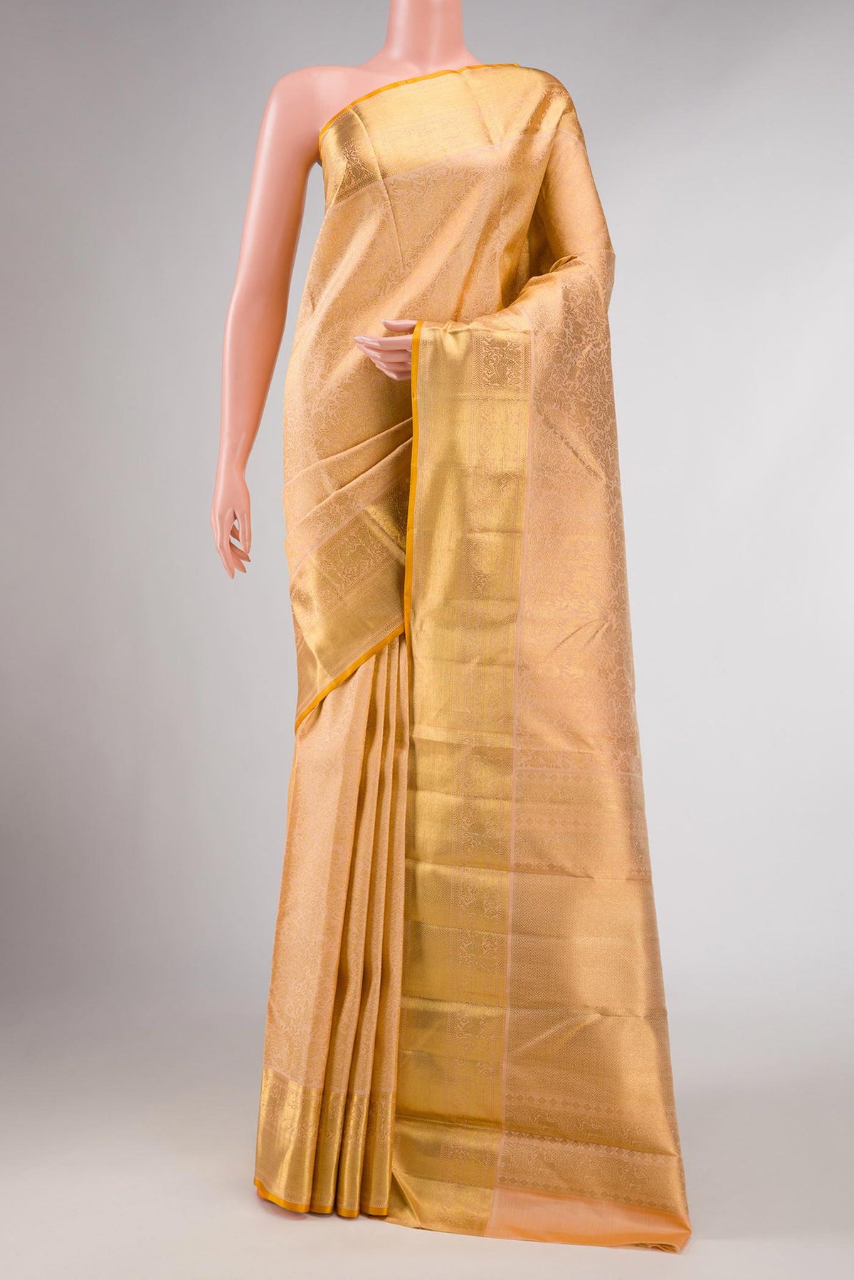 Pure Silk Pure Zari Golden Peach Dual Tone Kanchipuram Saree with Zari Brocade on the body and Zari Border displayed on a mannequin