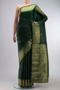Green Kanchipuram Silk Saree with Zari Butta on the body and Zari Border displayed on a mannequin