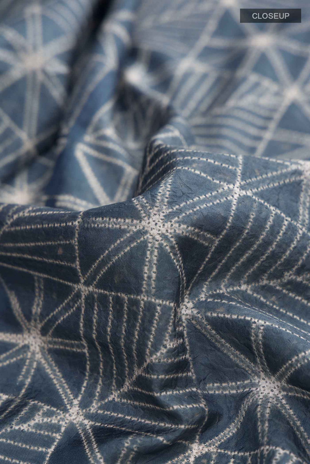 Close up of Blue Grey Printed Silk SareePrinted design on the body and Printed Border displaying folds