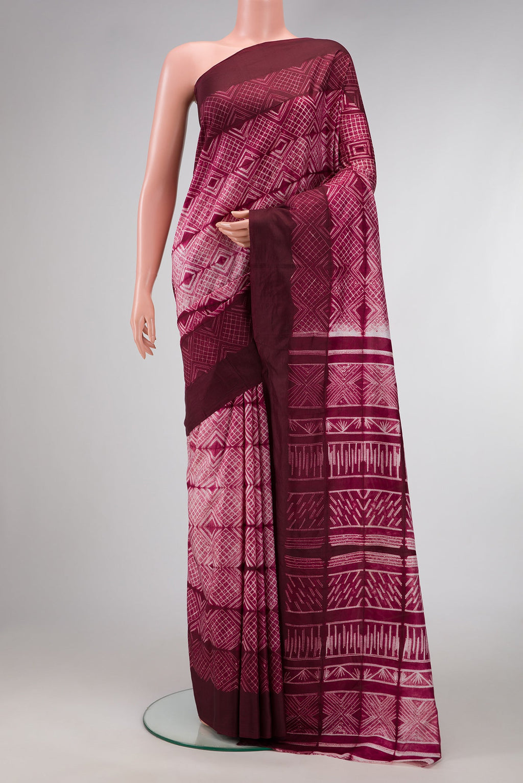 Maroon Dual Tone Tussar Silk Saree with Printed design on the body and Plain Border.  displayed on a mannequin