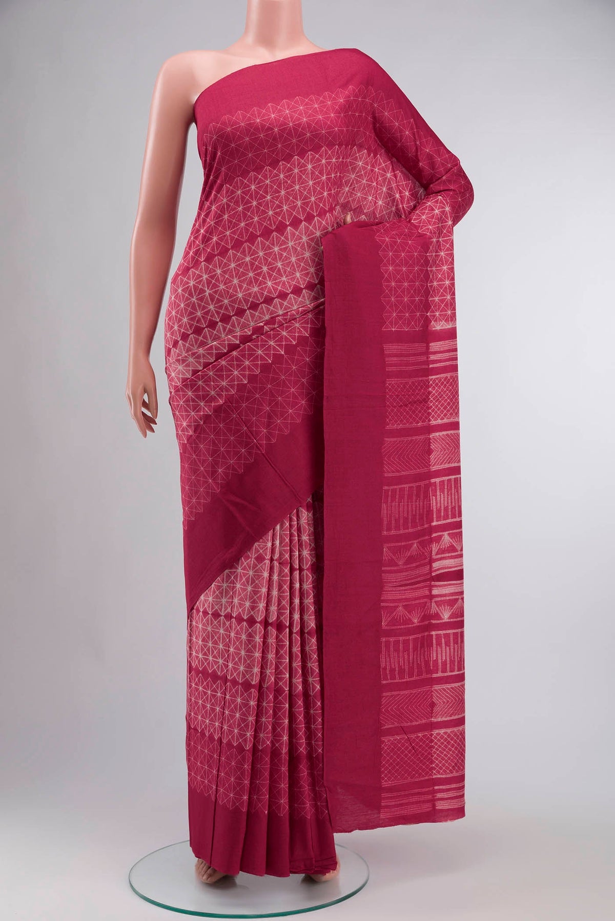 Red Tussar Silk Saree Printed design on the body and Plain Border displayed on a mannequin