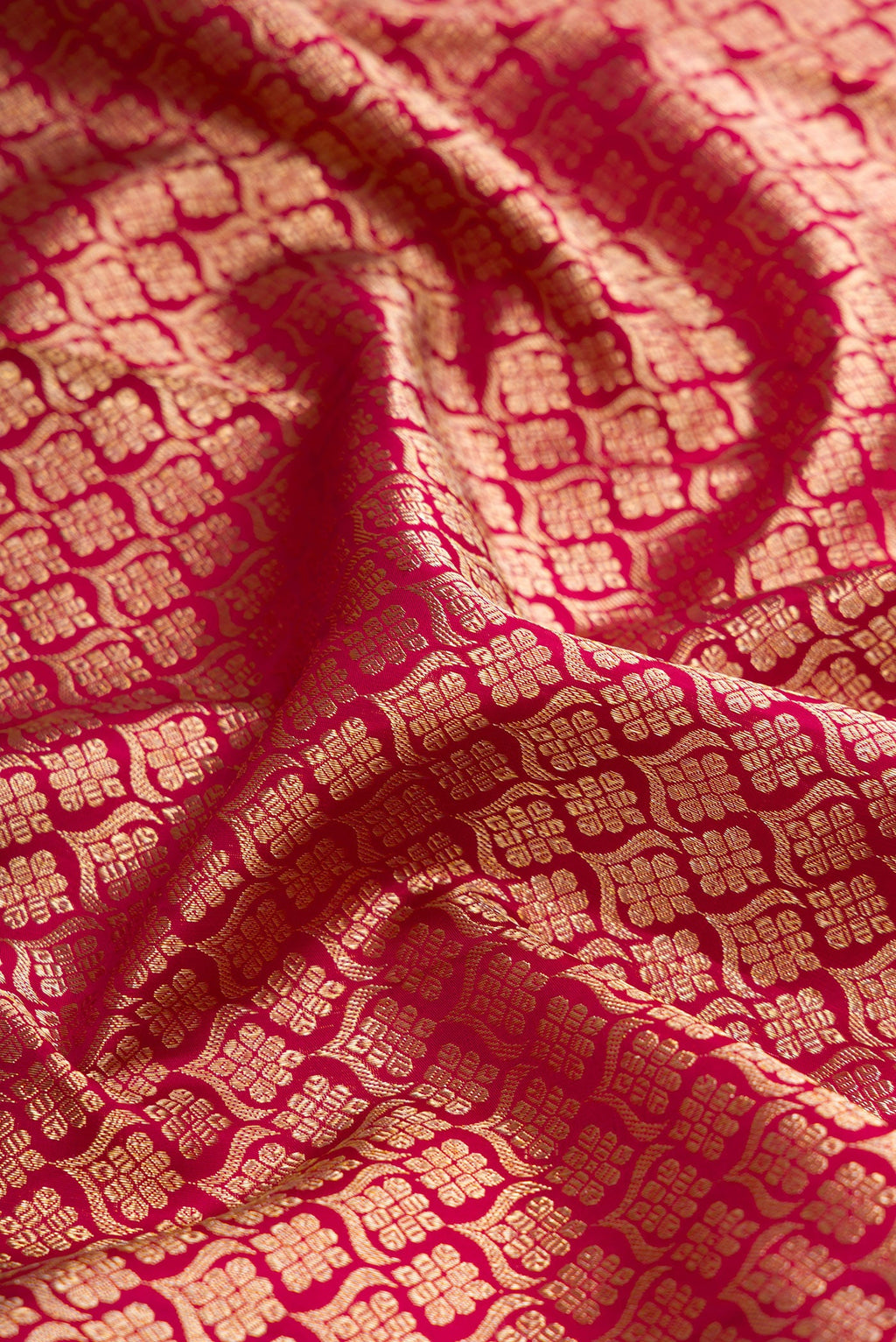 Close up of Magenta Dual Tone Kanjivaram Silk Saree with Zari Brocade on the body and Zari Border.  displaying folds