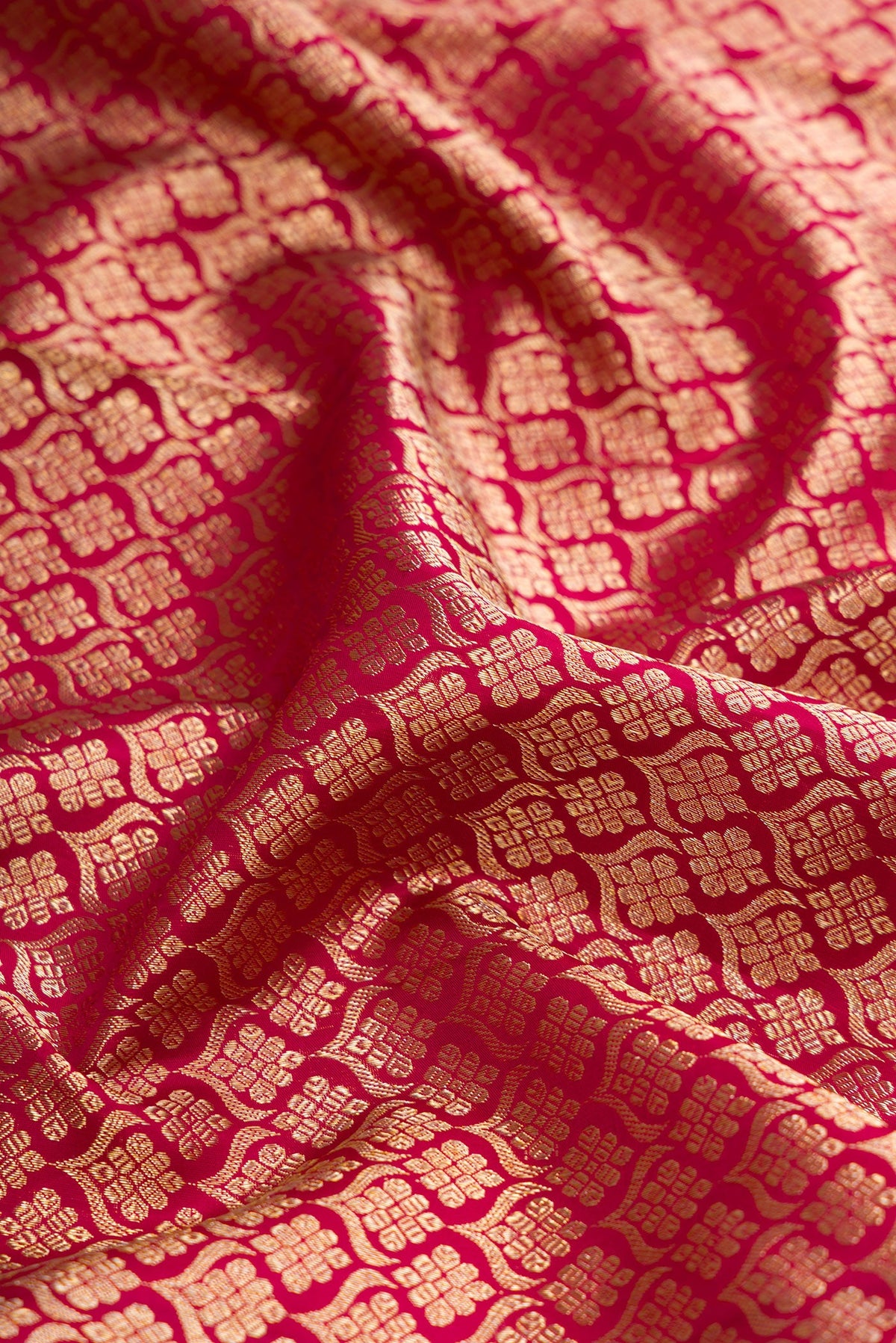 Close up of Magenta Dual Tone Kanjivaram Silk Saree with Zari Brocade on the body and Zari Border.  displaying folds