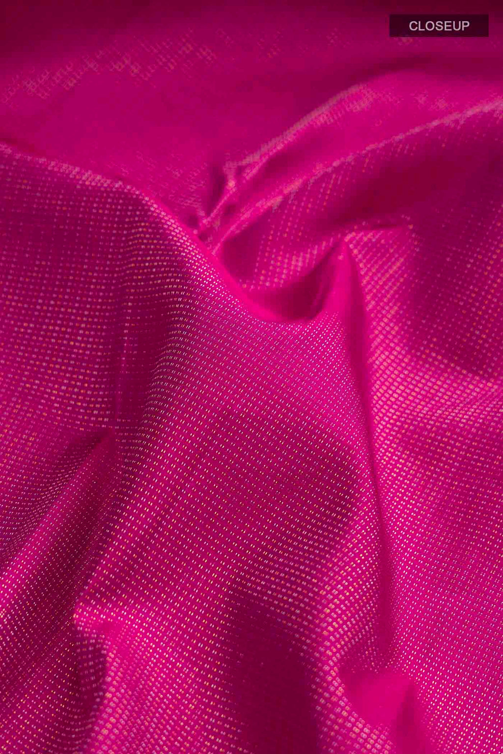 Close up of Pink Kanchipuram Silk Saree with Zari Butta on the body and Zari Border displaying folds