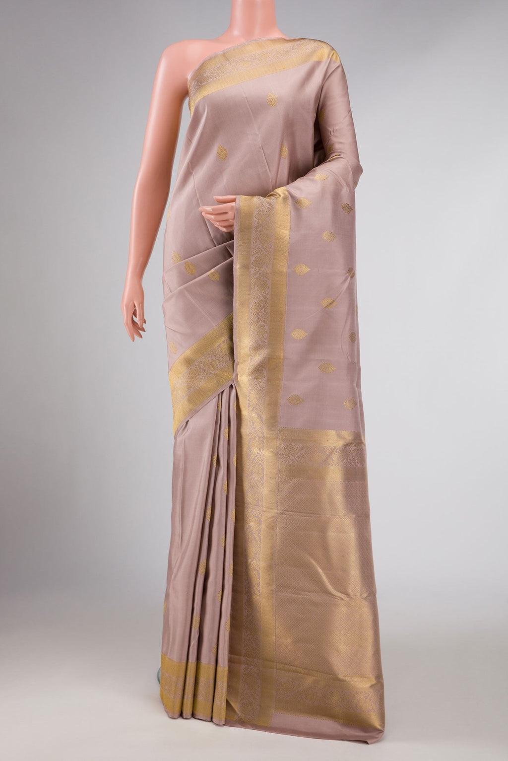 Pure Silk Pure Zari Rose Gold Dual Tone Kanchipuram Saree with Zari Butta on the body and Zari Border displayed on a mannequin