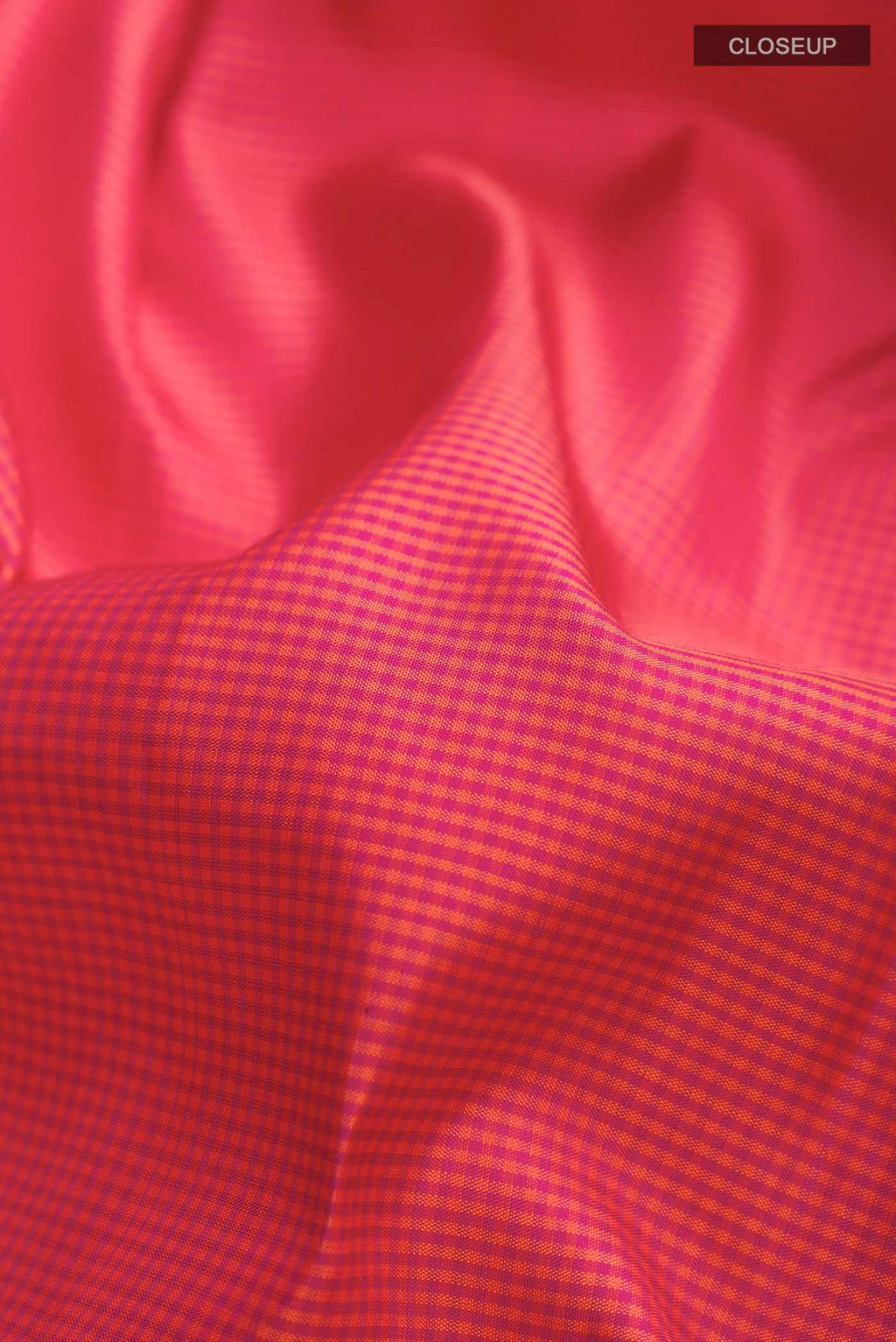 Close up of Pink Kanchipuram Silk Saree with Checked design on the body and Zari Border displaying folds