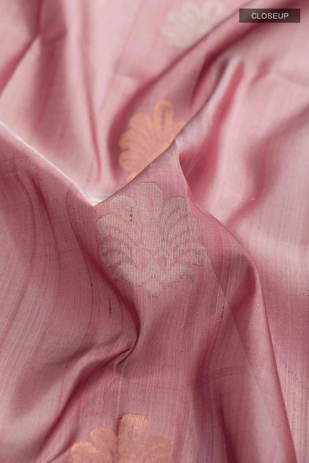 Close up of Mauve Uppada Silk Saree with Zari Butta on the body and Zari Border displaying folds