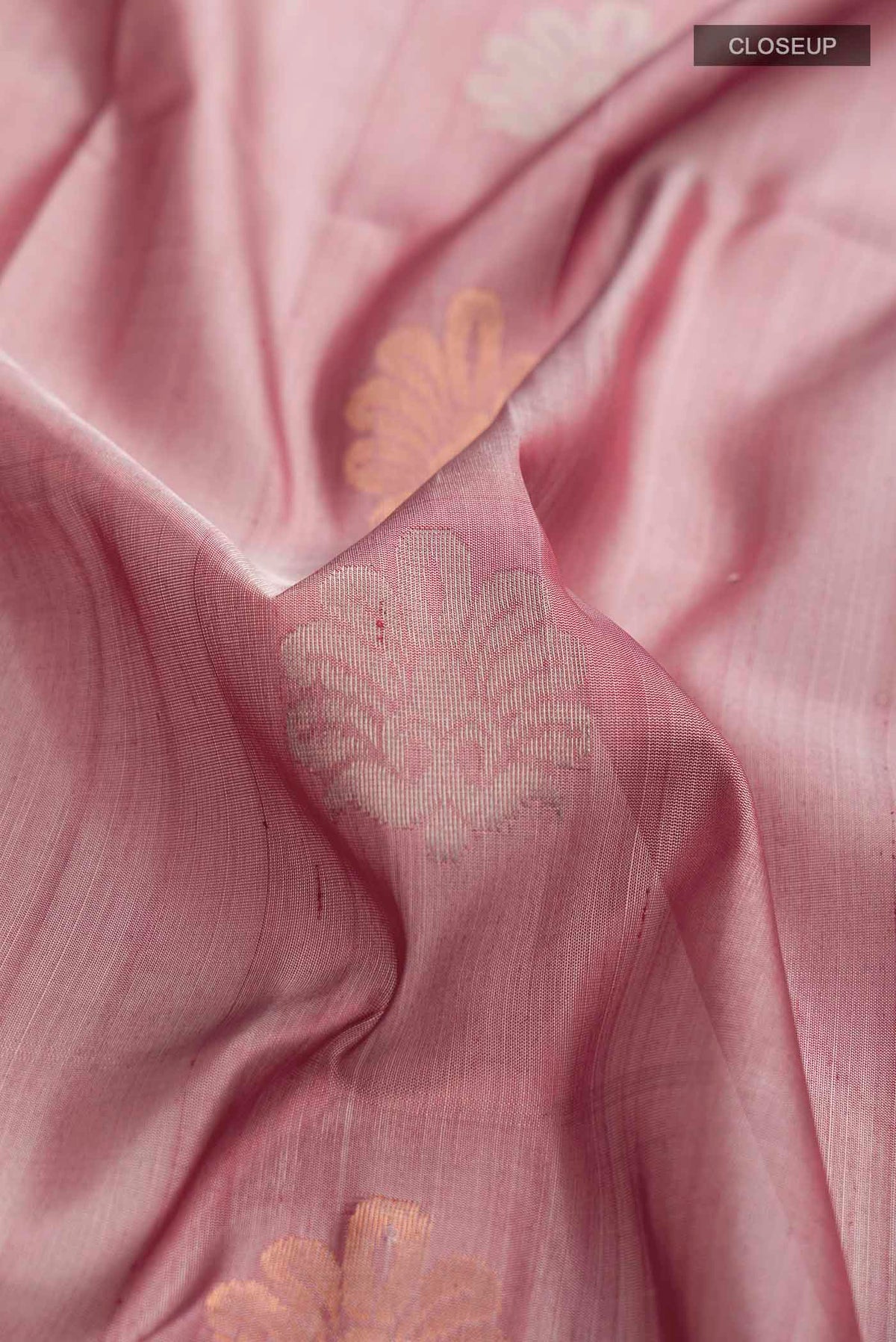 Close up of Mauve Uppada Silk Saree with Zari Butta on the body and Zari Border displaying folds