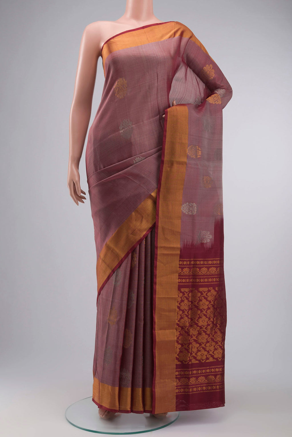 Mauve Uppada Silk Saree with Zari Butta on the body and Zari Border displayed on a mannequin