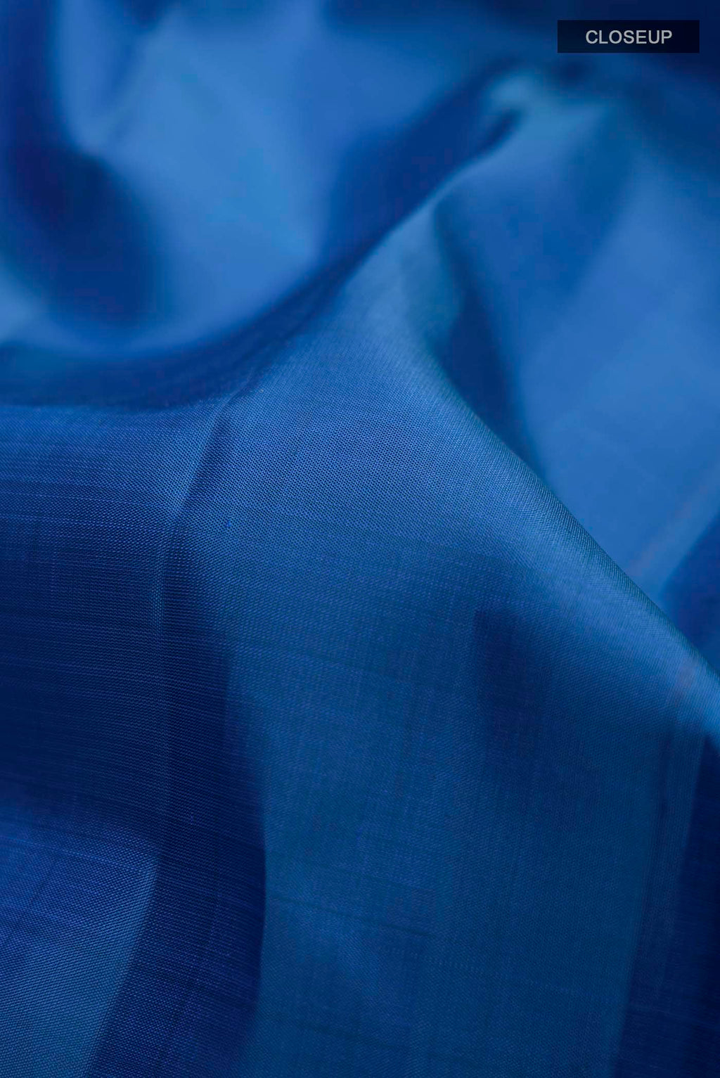 Close up of Blue Kanchipuram Silk Saree with Zari Butta on the body and Zari Border displaying folds