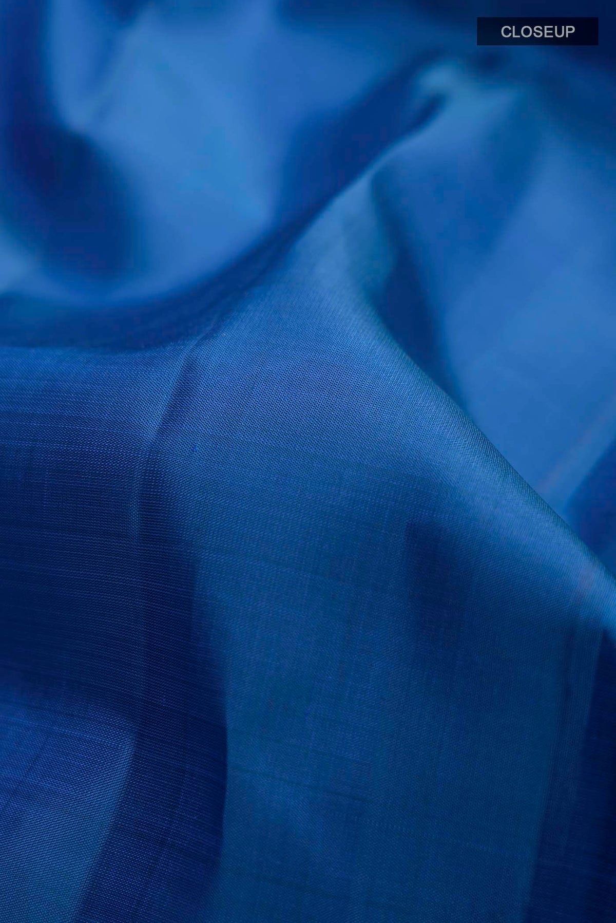 Close up of Blue Kanchipuram Silk Saree with Zari Butta on the body and Zari Border displaying folds