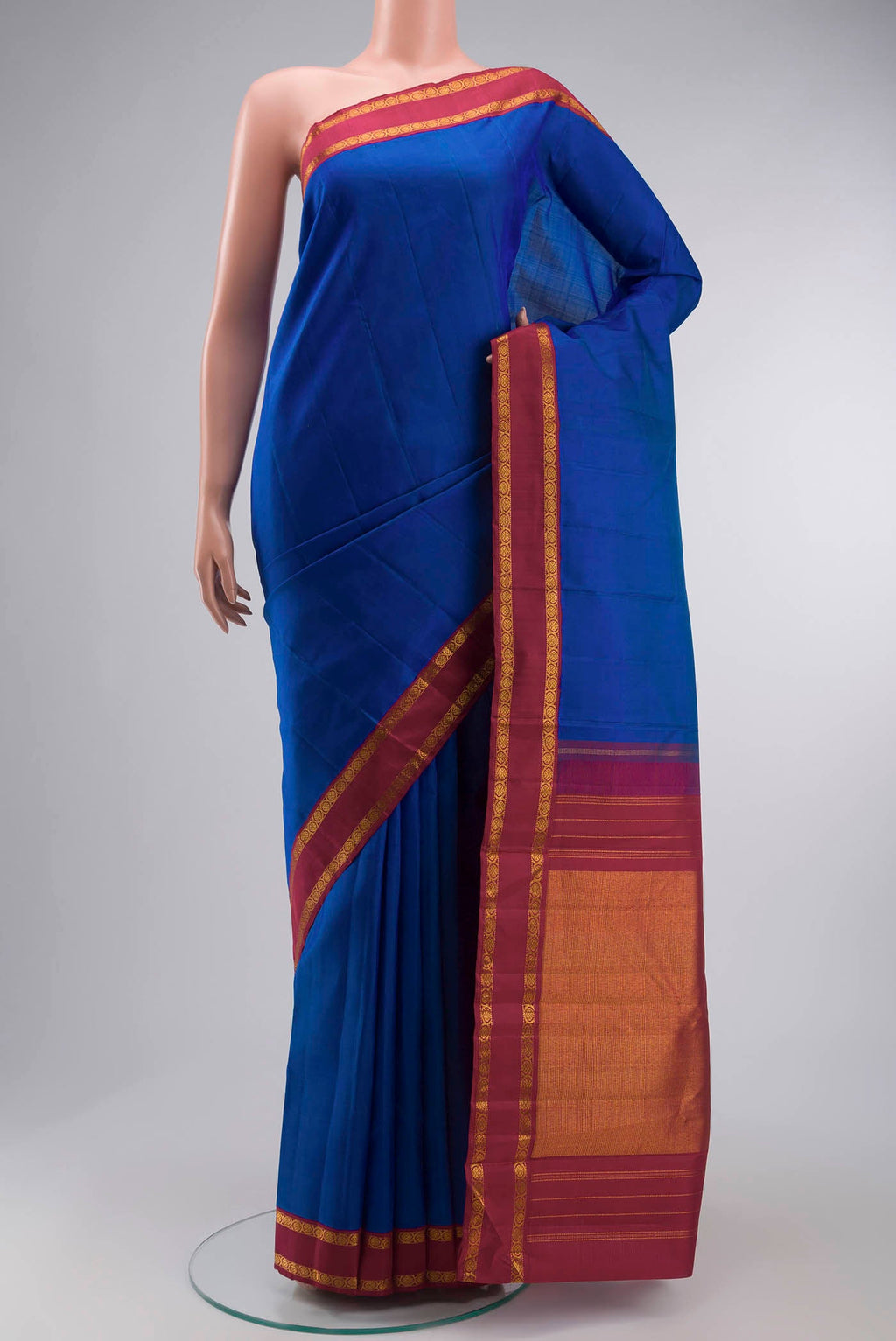 Blue Kanchipuram Silk Saree with Zari Butta on the body and Zari Border displayed on a mannequin