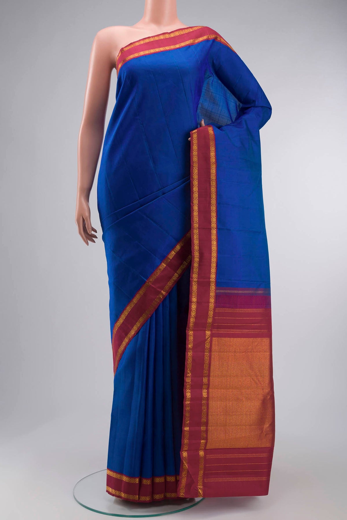 Blue Kanchipuram Silk Saree with Zari Butta on the body and Zari Border displayed on a mannequin