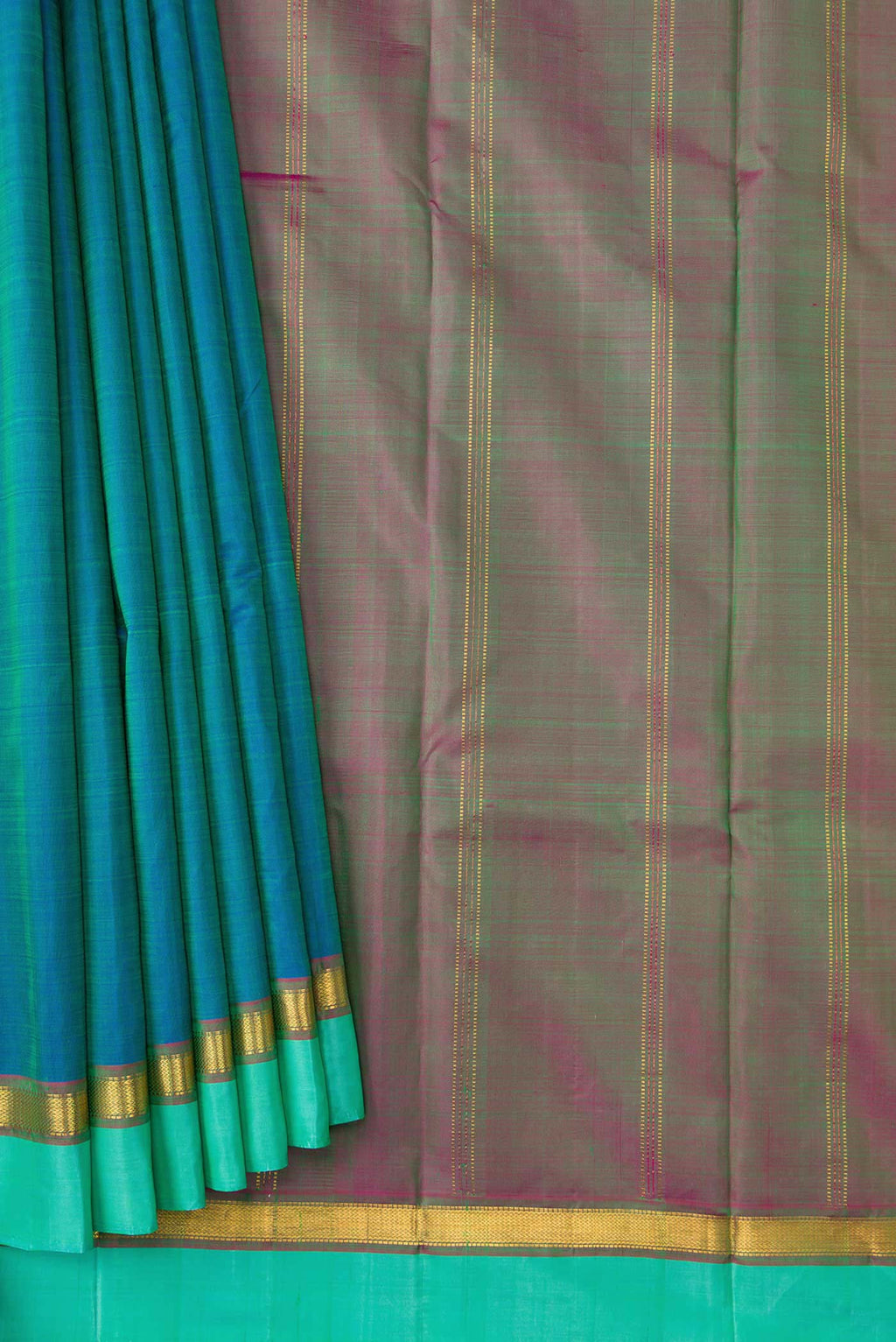 Pleats and pallu of Peacock Blue Dual Tone Kanchipuram Silk Saree with Plain Body and Zari Border