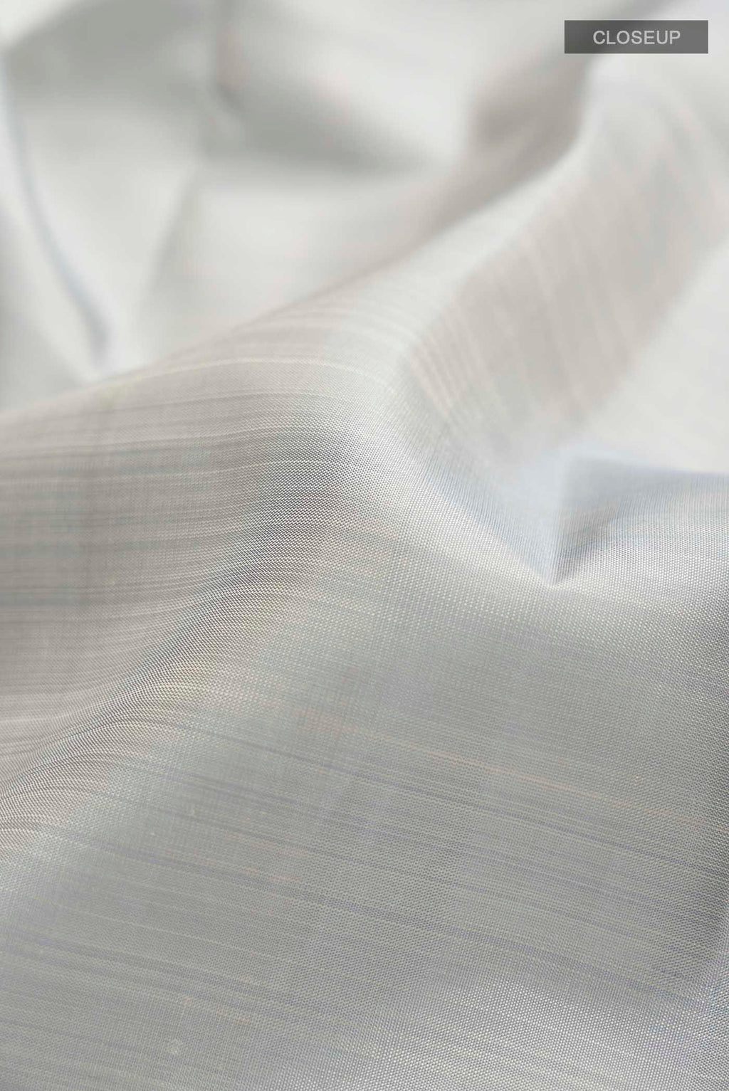 Close up of Grey Kanchipuram Silk Saree with Plain Body and Zari Border displaying folds
