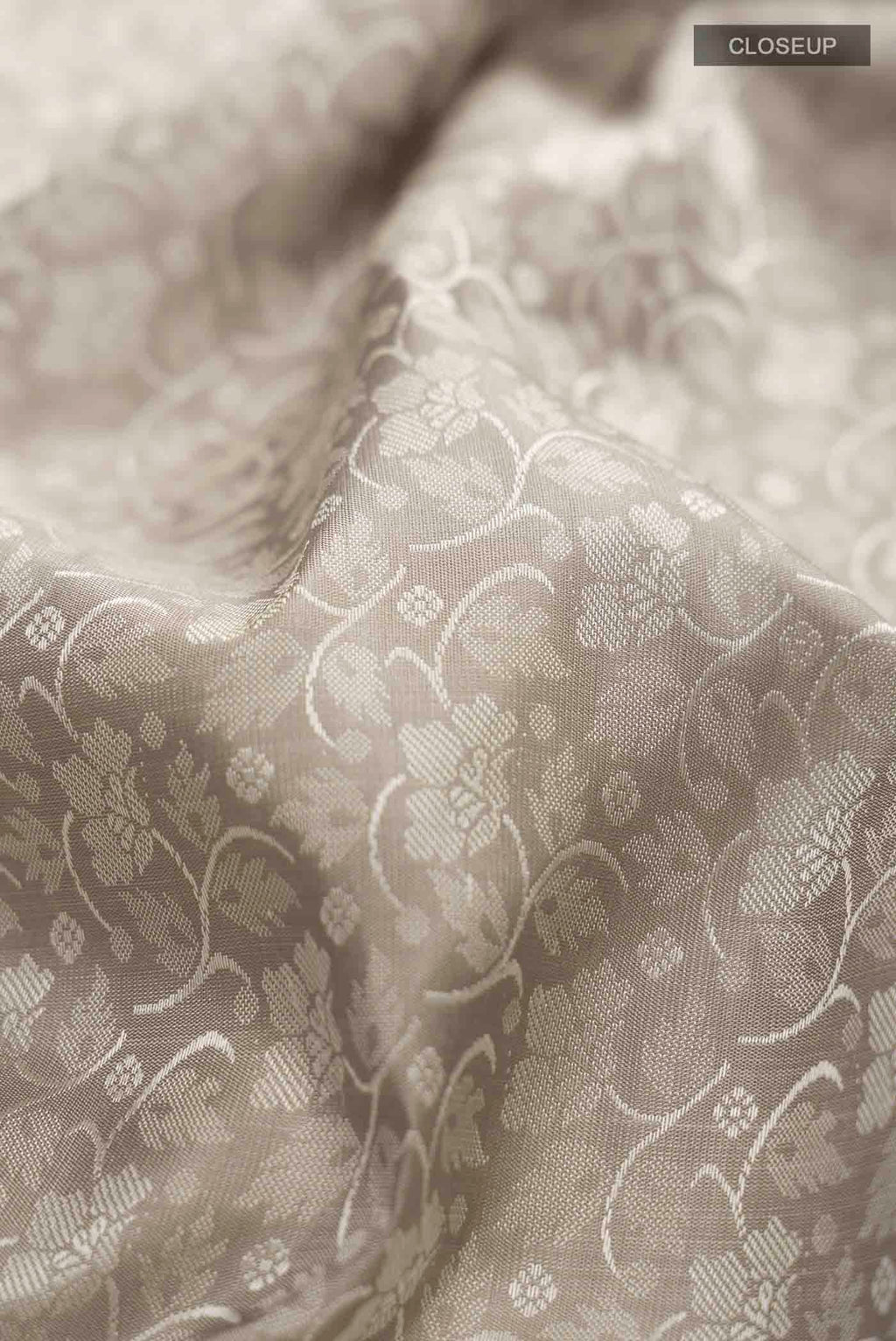 Close up of Grey Kanchipuram Silk Saree with Jacquard design on the body and Zari Border displaying folds