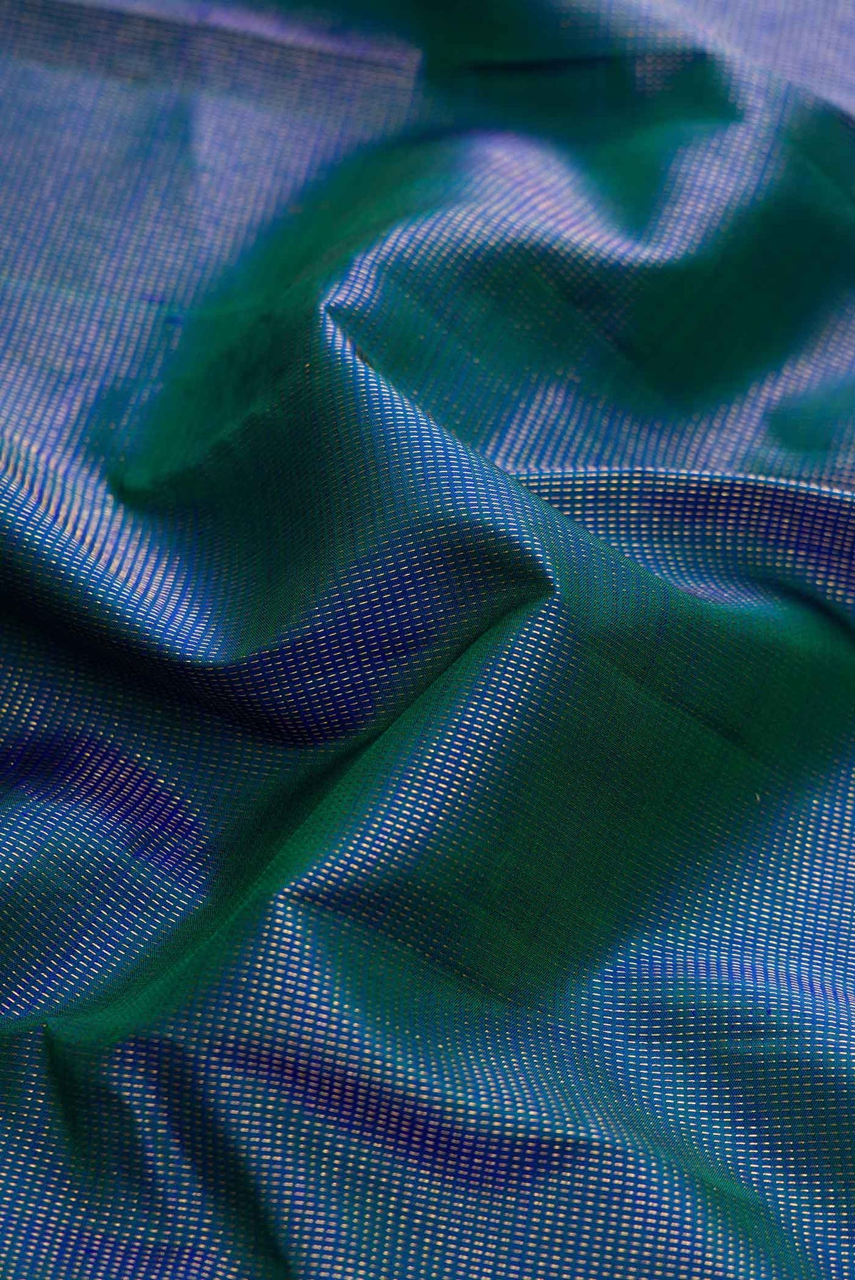 Close up of Peacock Blue Dual Tone Kanchipuram Silk Saree with Stripes on the body and Zari Border displaying folds